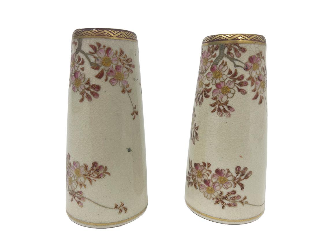 Japanese Satsuma mini vases, ca. 1900

Meiji period (1867-1912) Japanese Satsuma vases of 9.2 cm high in a conical-cylindrical shape with measurement of 4.2 cm diagonal at the base and the top of 3 cm diagonal.
The scene with branches with