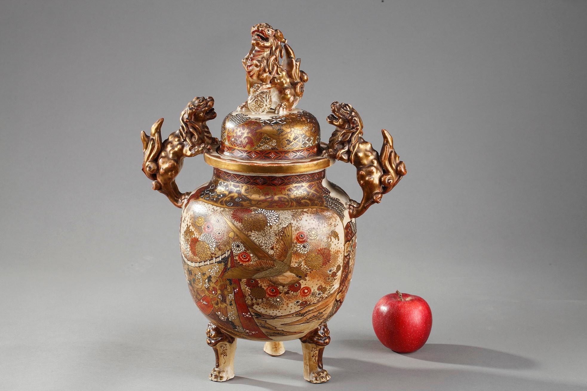 Tripod Satsuma perfume-burner painted in polychrome enamels and gold. The paunch is decorated with Japanese courtiers, the reverse with birds in landscapes. The shoulder and lid are embellished with flowers and geometric patterns. The handles and