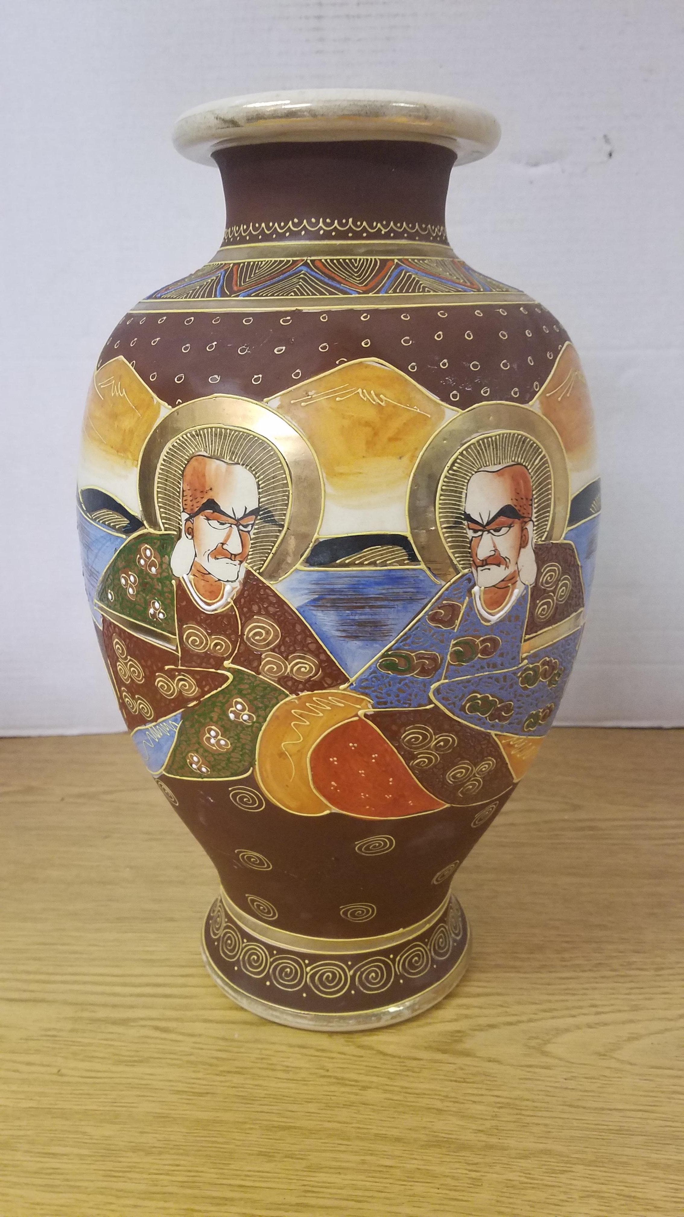 Beautifully detailed and hand painted Japanese Satsuma vase. Matte Burgundy background with vibrant gold gilding. Some of the gilding is raised for a 3 dimensional look. There is also raised painted details in small dotting throughout the vase. See