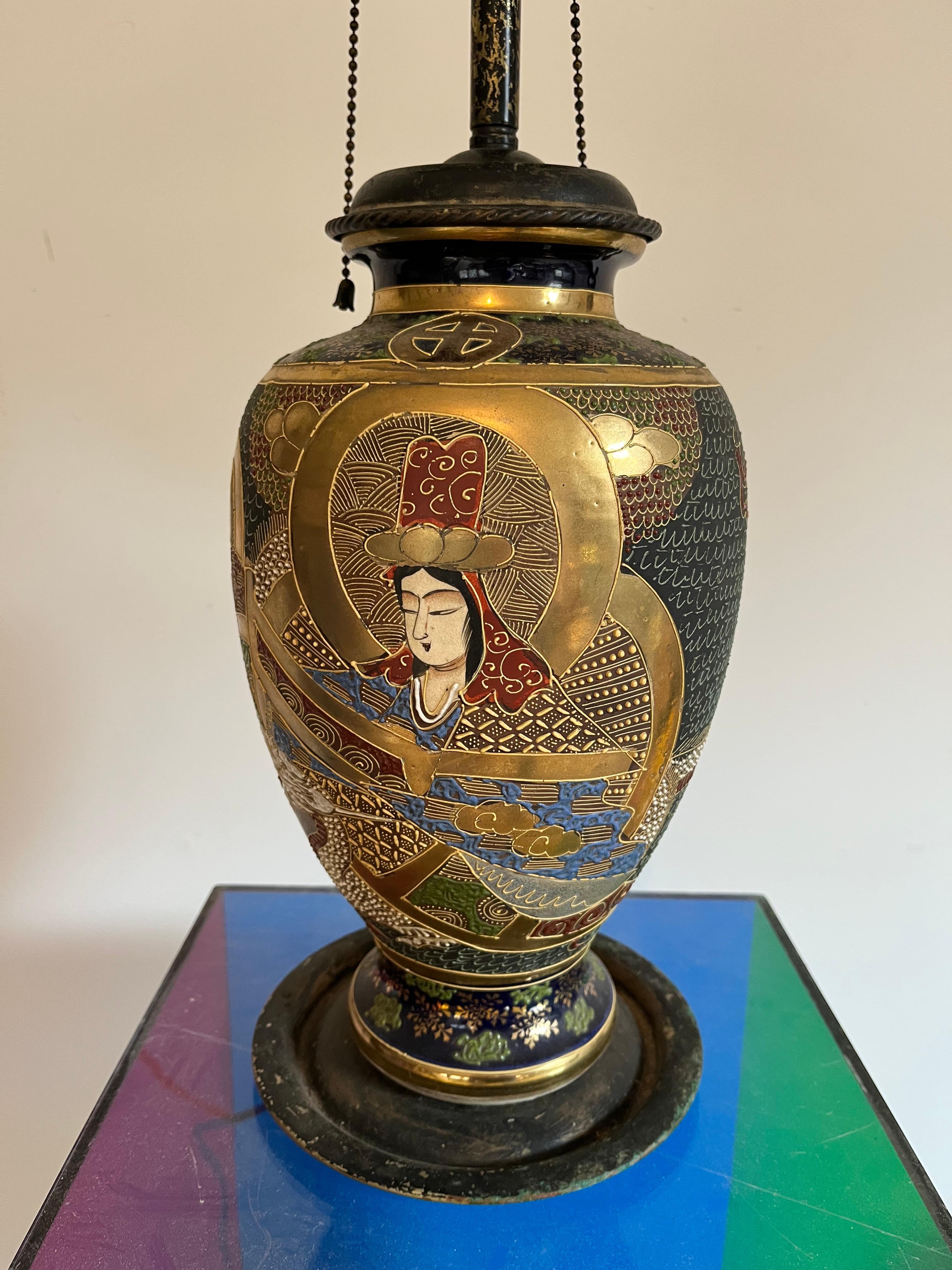 An early Satsuma vase depicting a Japanese nobleman and woman on two panels front and back, with gilt decoration and painted details overall. Now mounted as a lamp. 