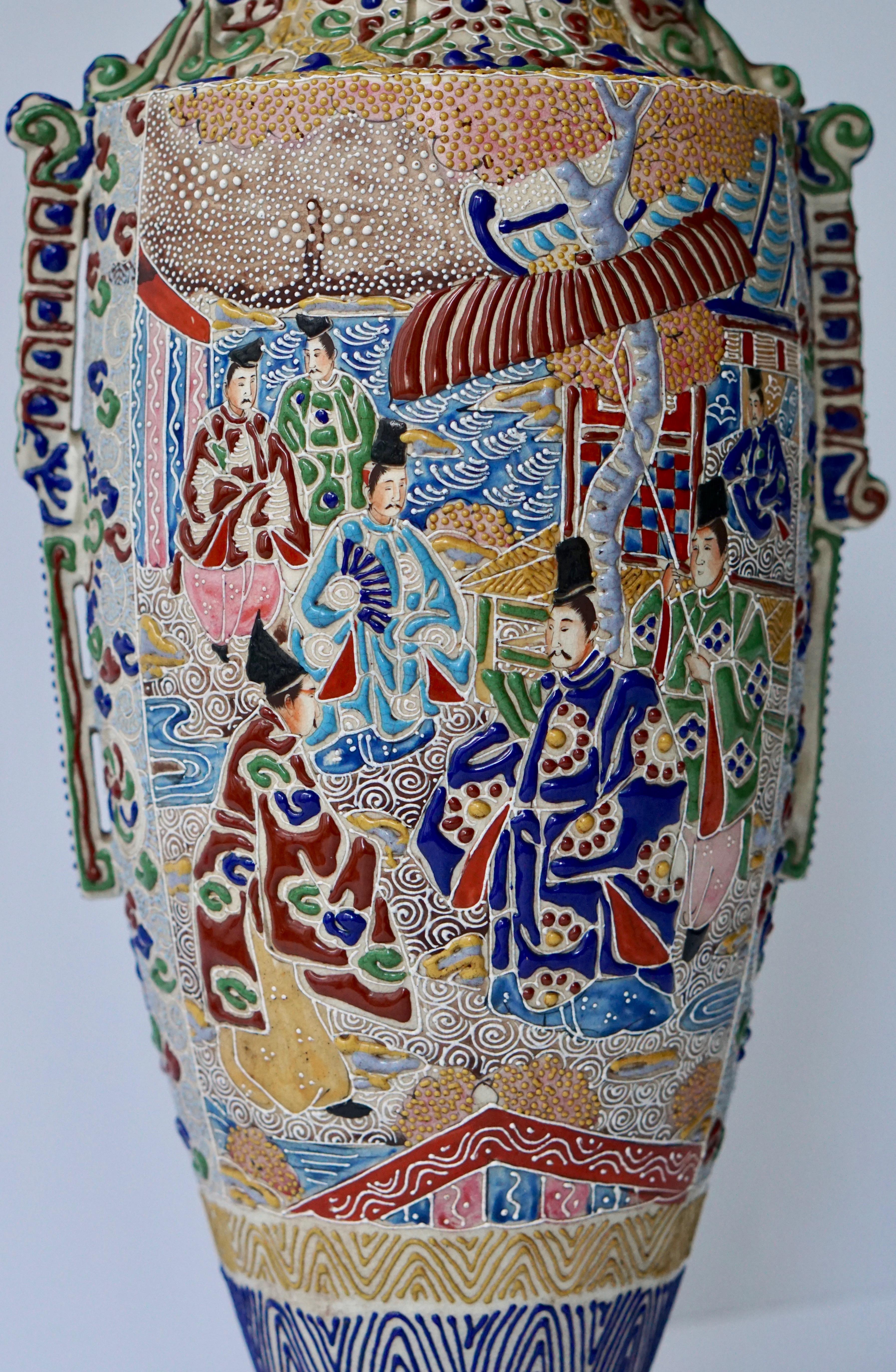 A mid-20th century Japanese Satsuma vase with figures.

 Satsuma ware is a style of Japanese earthenware originally from the Satsuma region of what is today southern Kyushu. There are two distinct categories of this ware: The original plain dark