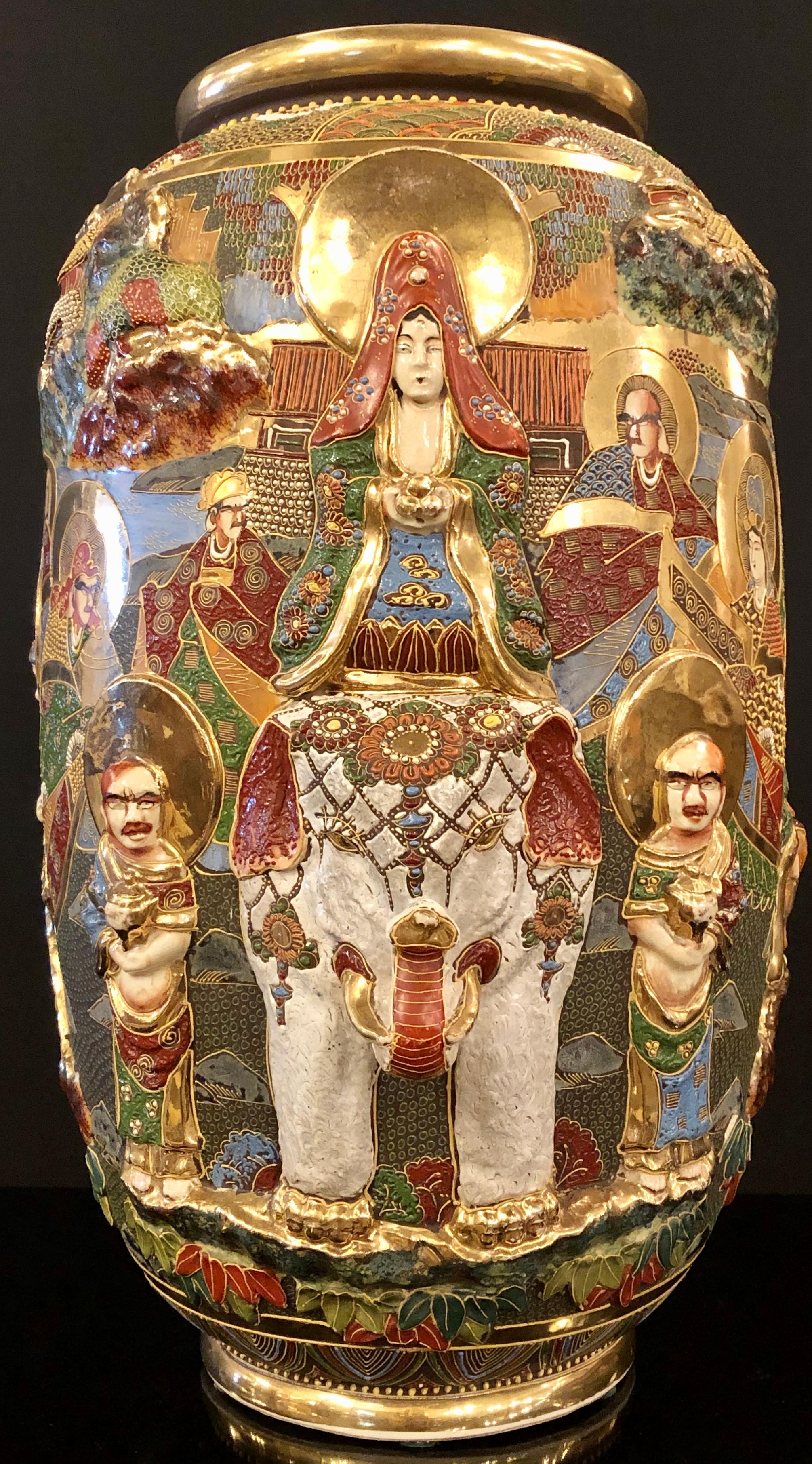 Japanese Satsuma vase with gold gilt high relief decoration with the goddess Quan Yin mounted on a raised elephant. Signed on bottom with signature and label. One of several large decorated vase or urns available.