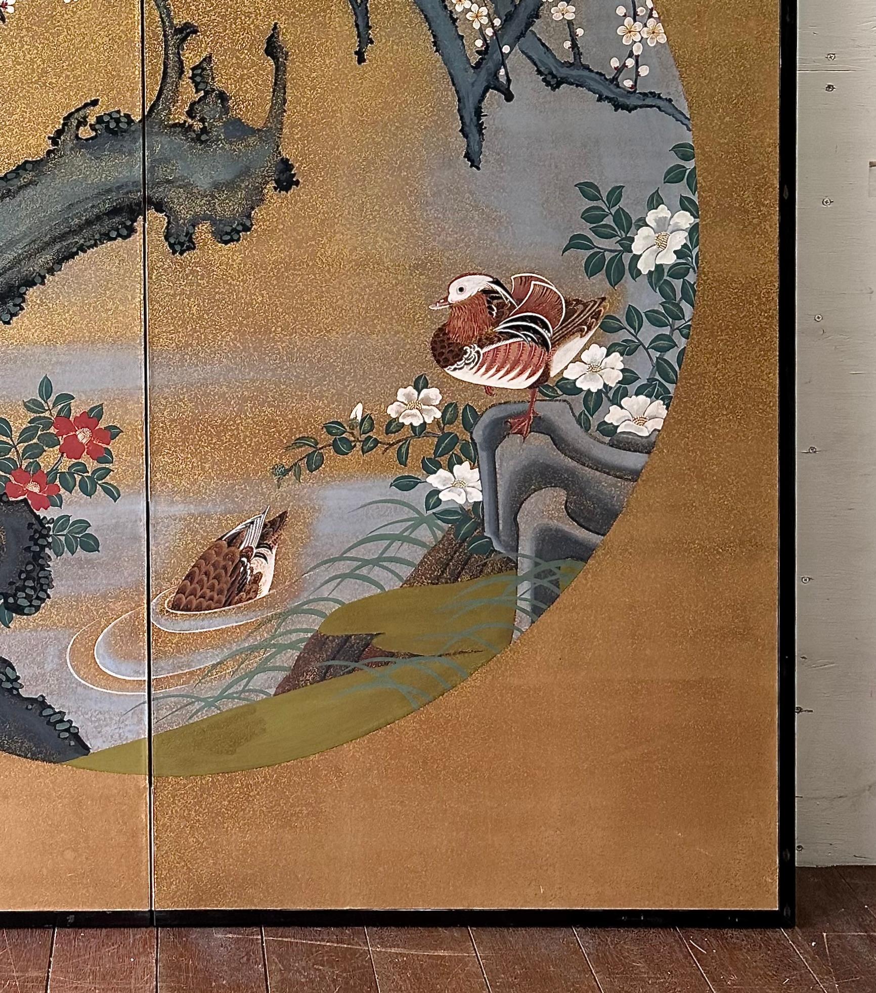 At the heart of this golden composition are mandarin ducks, long celebrated in East Asian art as enduring symbols of love, fidelity, and harmony. Surrounded by plum blossoms — heralds of resilience and renewal — the scene evokes serenity and