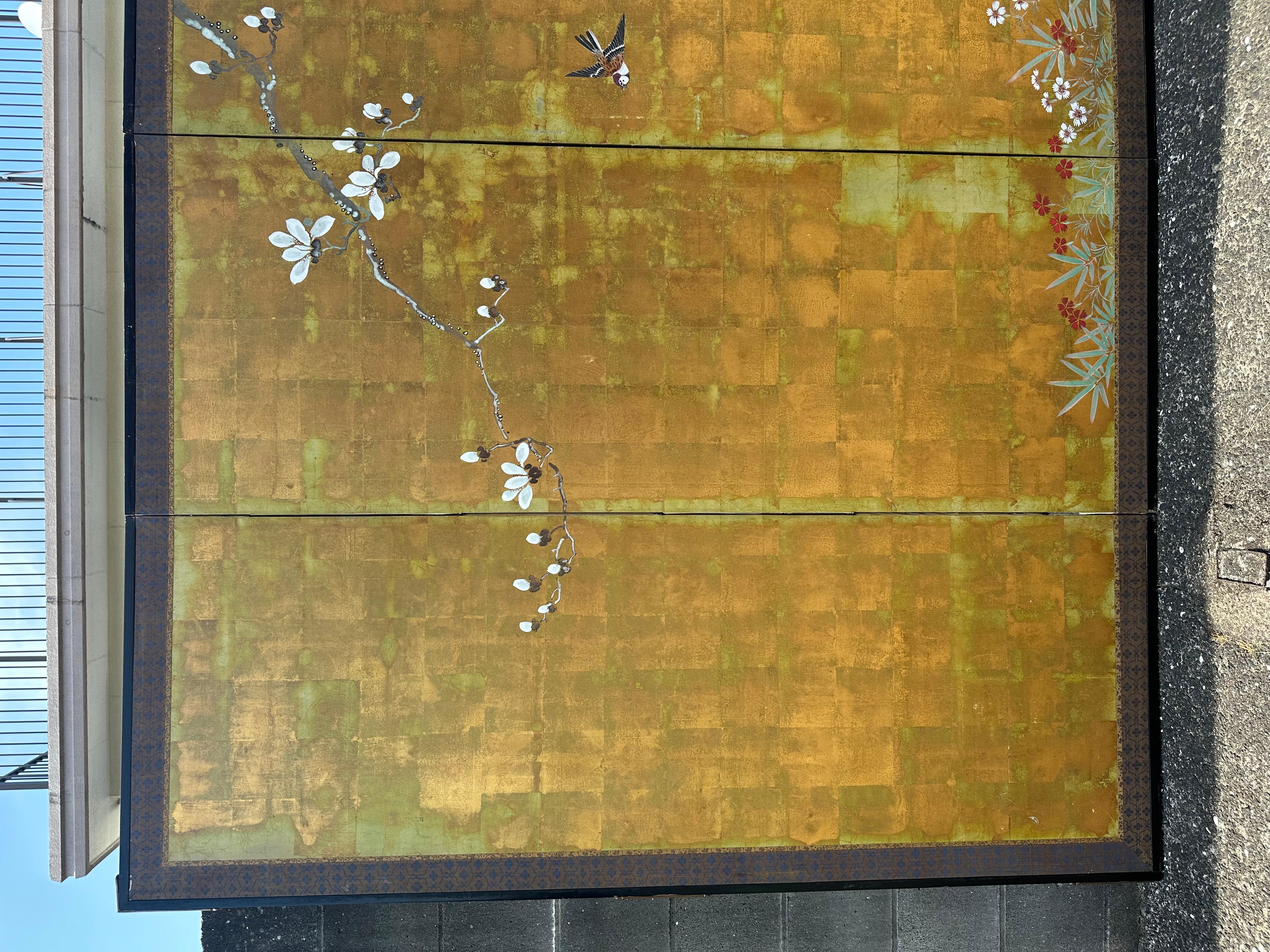 Bathed in radiant gold, Melody of Magnolia Blossoms captures the fleeting harmony of nature in bloom. A graceful magnolia branch arcs across the shimmering surface, its petals unfolding in soft light, while small birds hover and rest among the