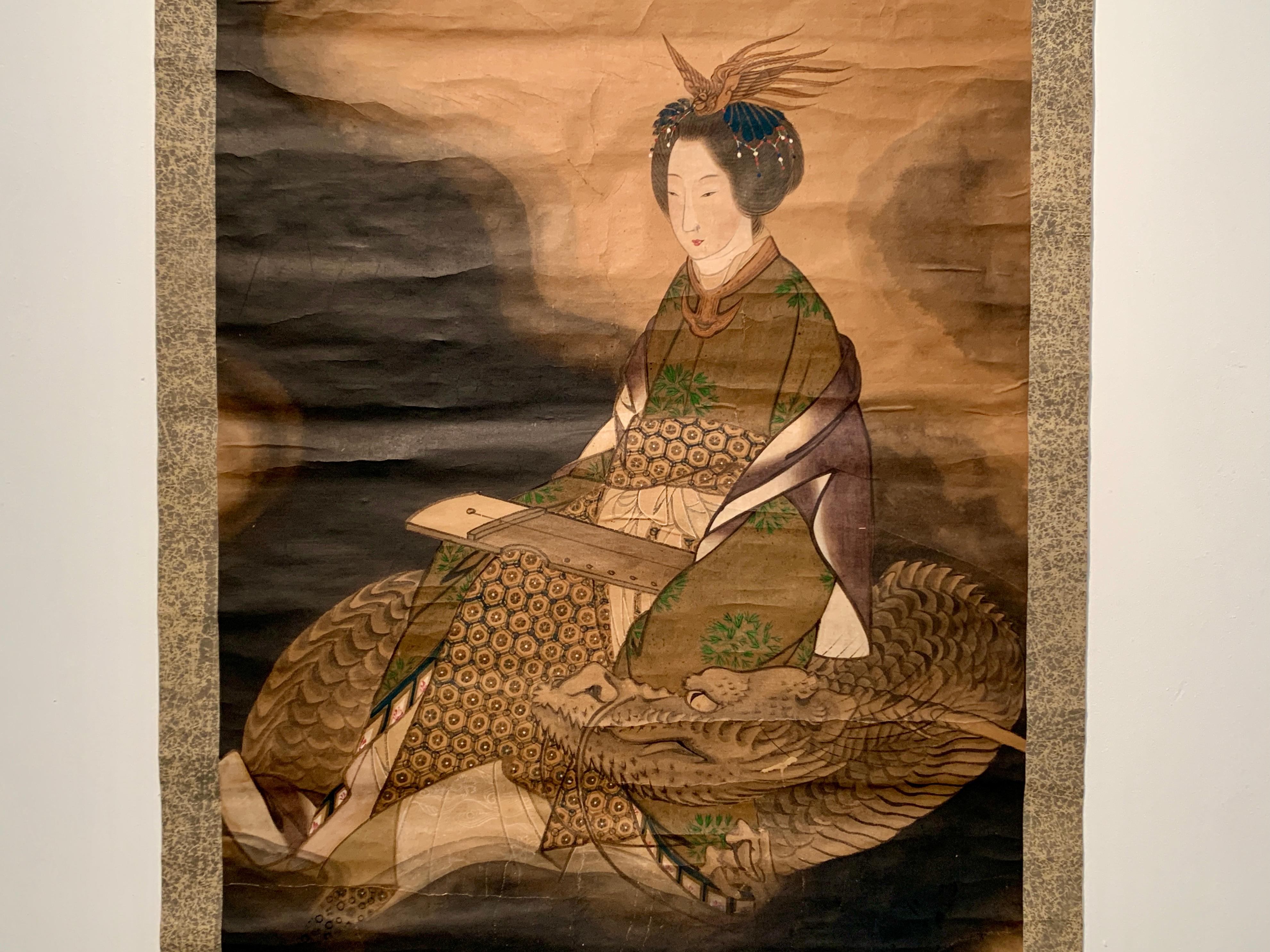 A powerful and brooding Japanese hanging scroll painting of the goddess Benzaiten riding a dragon, ink and color on paper, mounted on paper, with silk brocade, Taisho Period, early 20th century, Japan

This hanging scroll, kakemono or kakejiku, is