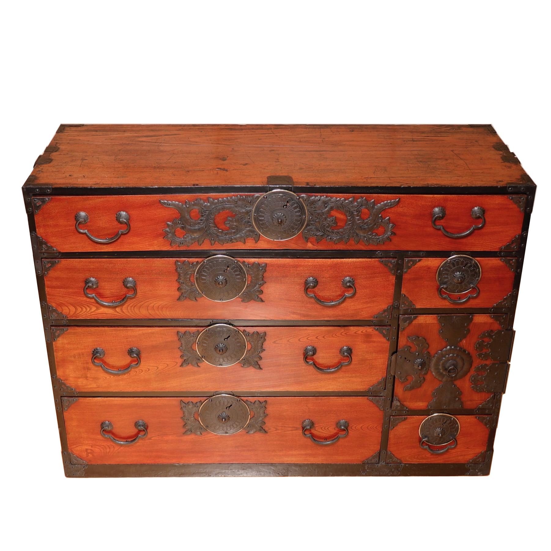 Japanese Isho Yaro-dansu (single section clothing storage chest) from Sendai, constructed of hinoki (Japanese Cypress) with keyaki (Zelkova) drawer fronts finished in a rich reddish hand-rubbed kijiro lacquer with heavy iron hardware, melon shaped