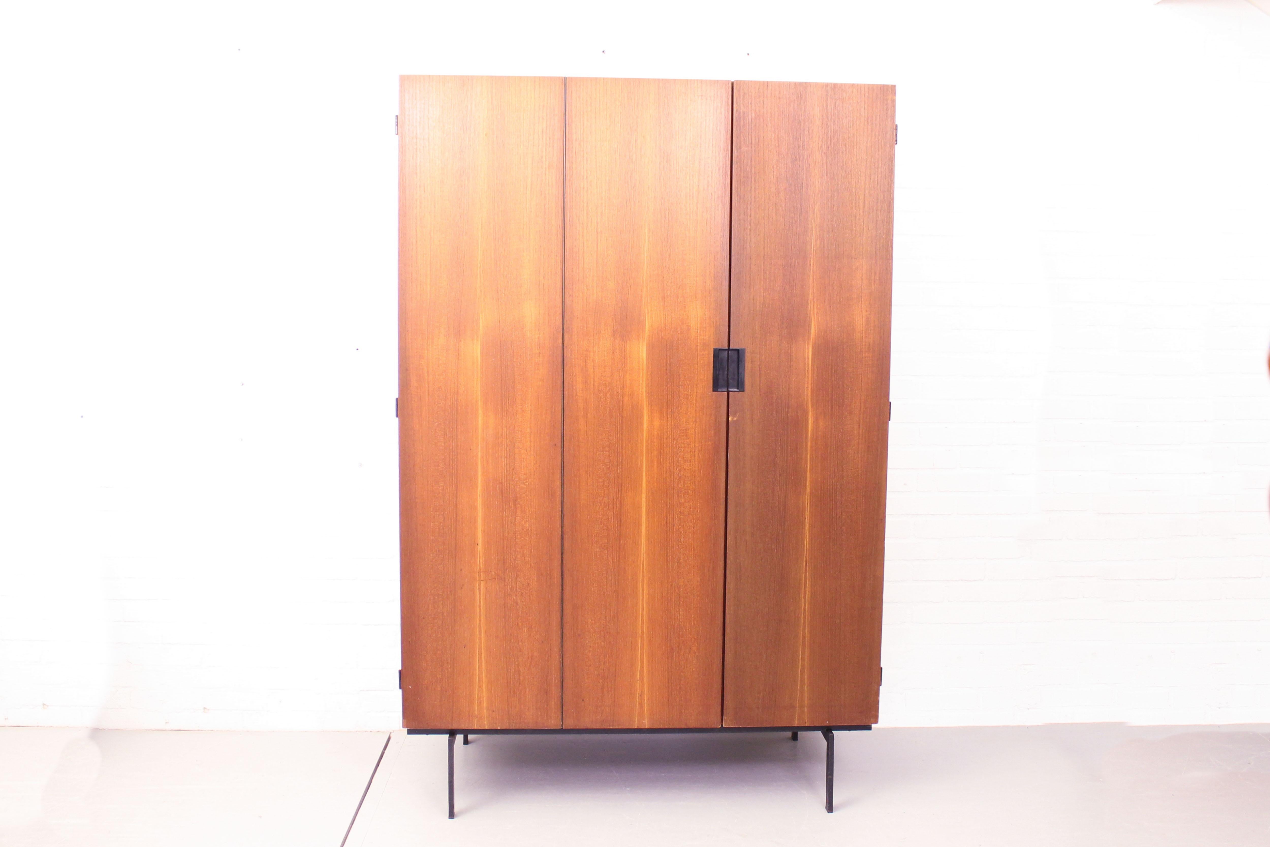 Very nice tall wardrobe KU10 from the famous Japanese series designed by Cees Braakman for Pastoe UMS, Holland, 1958. The wardrobe is made out of teak wood and has a black lacquered frame & black plastic minimalist handles. On the inside you will