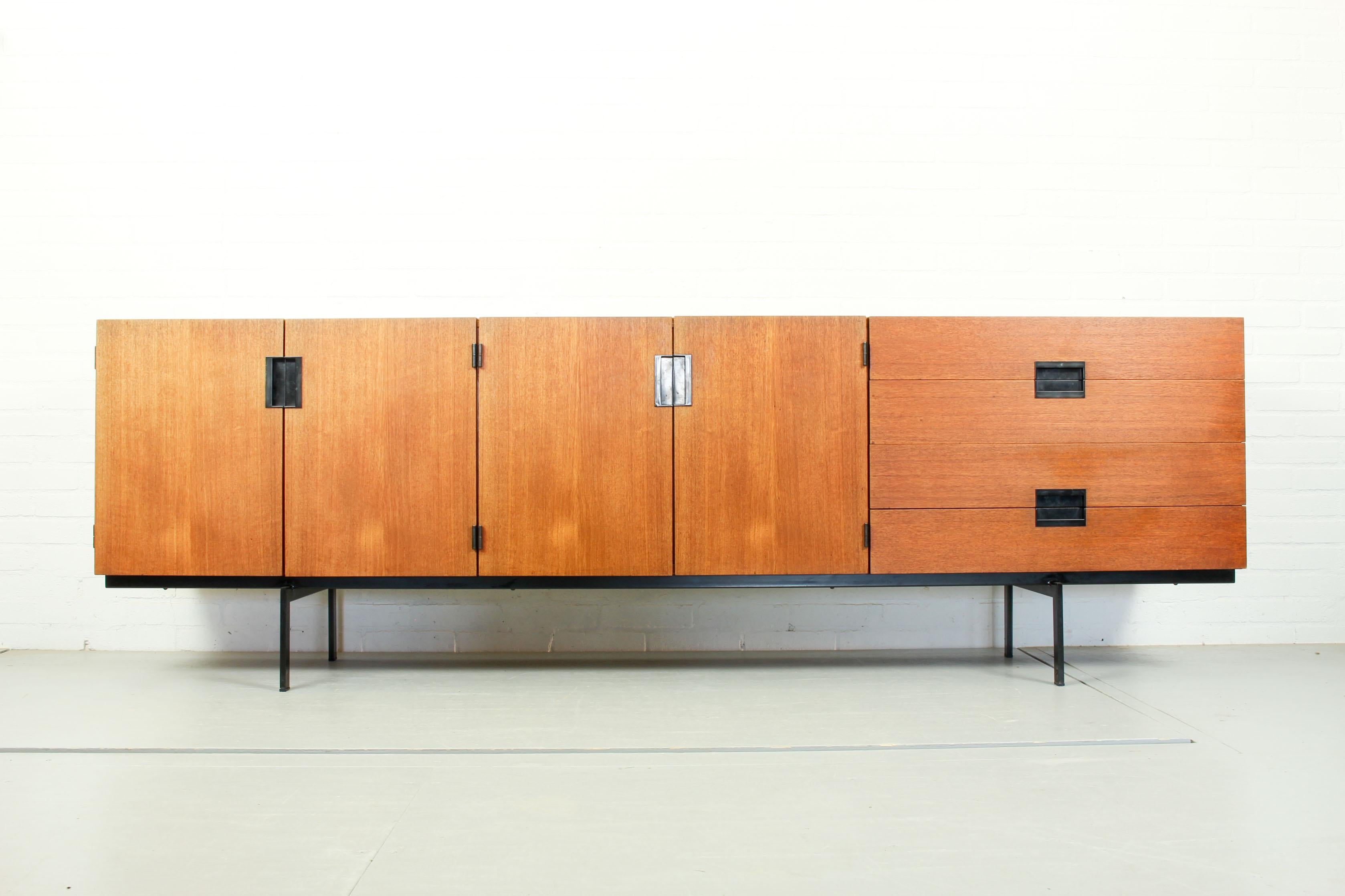 This sideboard, type DU03, is part of the Japanese series designed by Cees Braakman for Pastoe, 1958. The Minimalist design with black metal handles and black metal base is timeless and furniture of this Japanese series remains highly collectible.