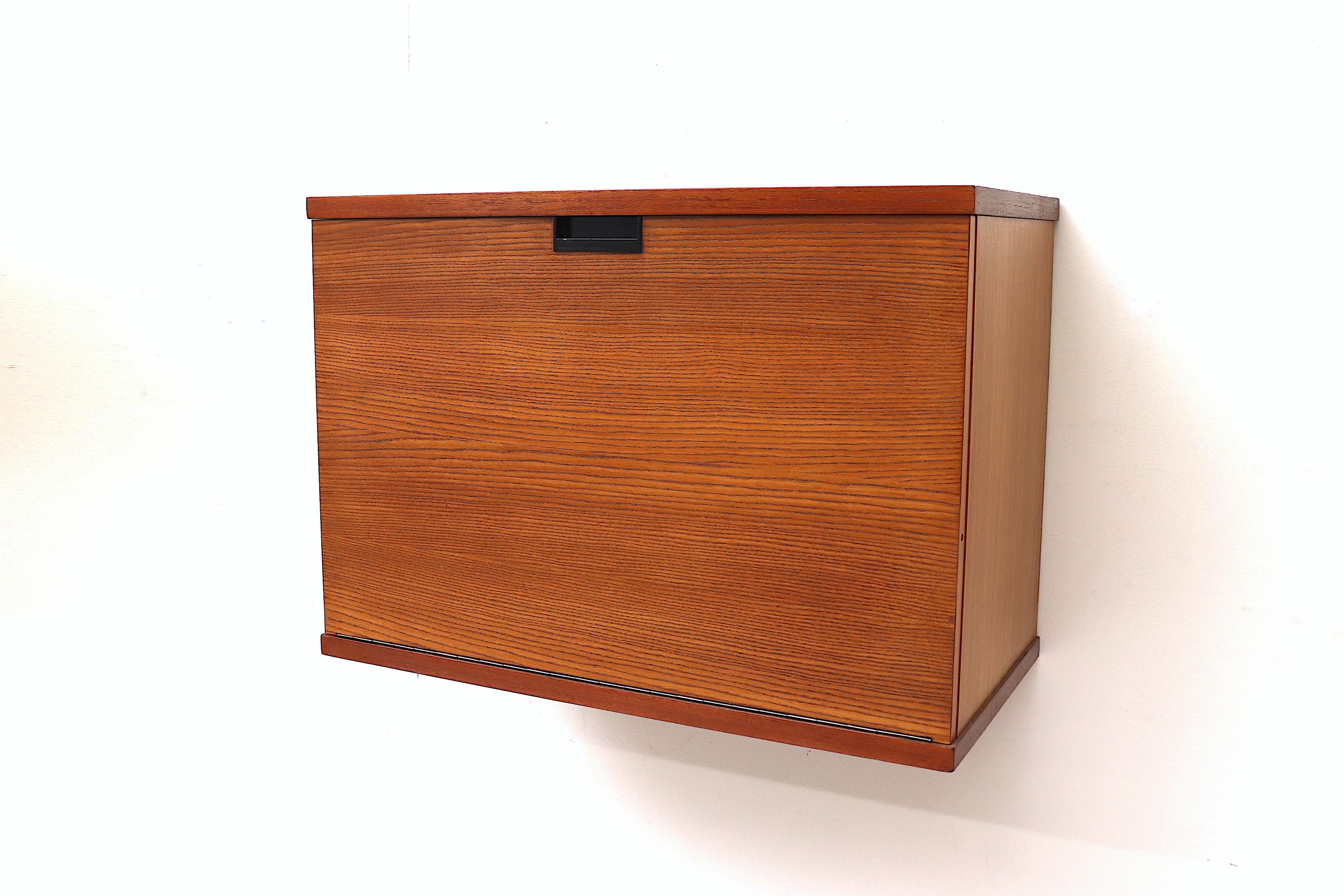 Beautiful teak Japanese series wall mount bar or desk with drop down door, oak interior and signature graphic handle pull. Lightly refinished with wear consistent with age and use. Another similar unit available with 2 toned wood (LU922418376812)