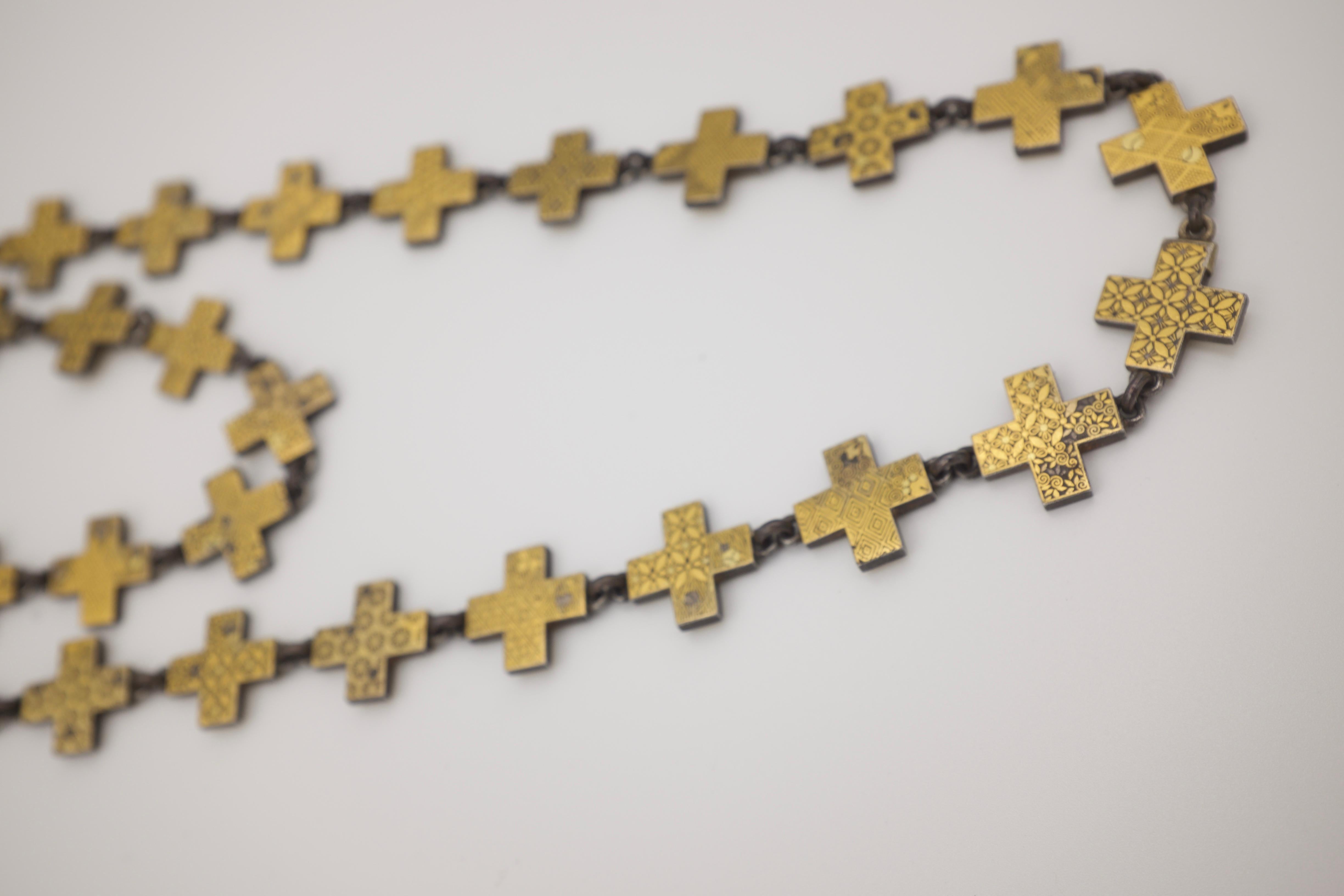 Each of the 72 crosses is hand carved in unique pattern of wonderful symmetry.  Gold and Iron, this shakudo necklace is top quality and style.  Clasp is more recent, industrial, but cool.  