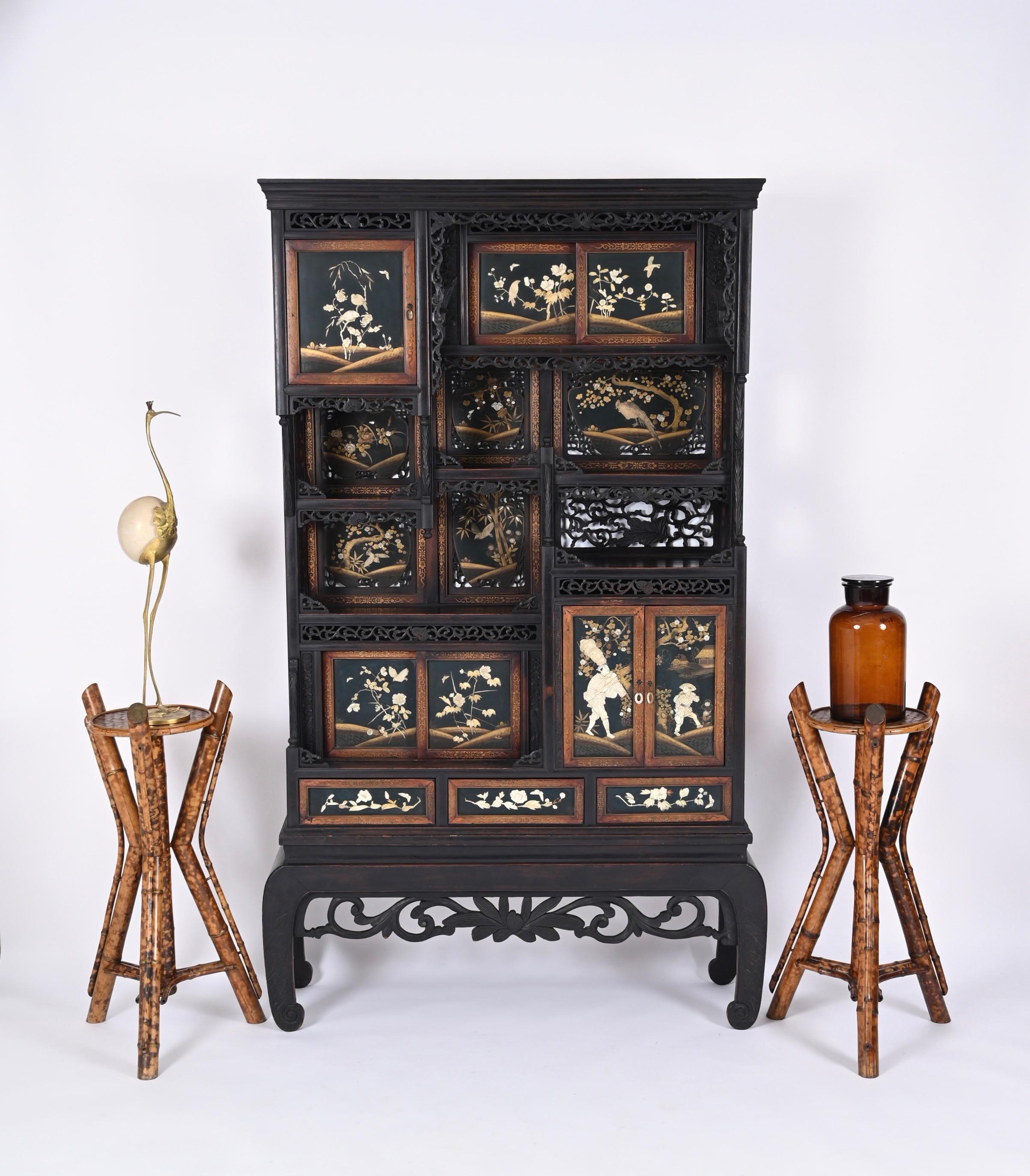 Outstanding Shibayama cabinet from the Meiji period in black lacquered and hand-carved wood with marvellous arrangement of sliding and hinged doors and drawers decorated with precious materials such as mother pearl and gold. This incredible and