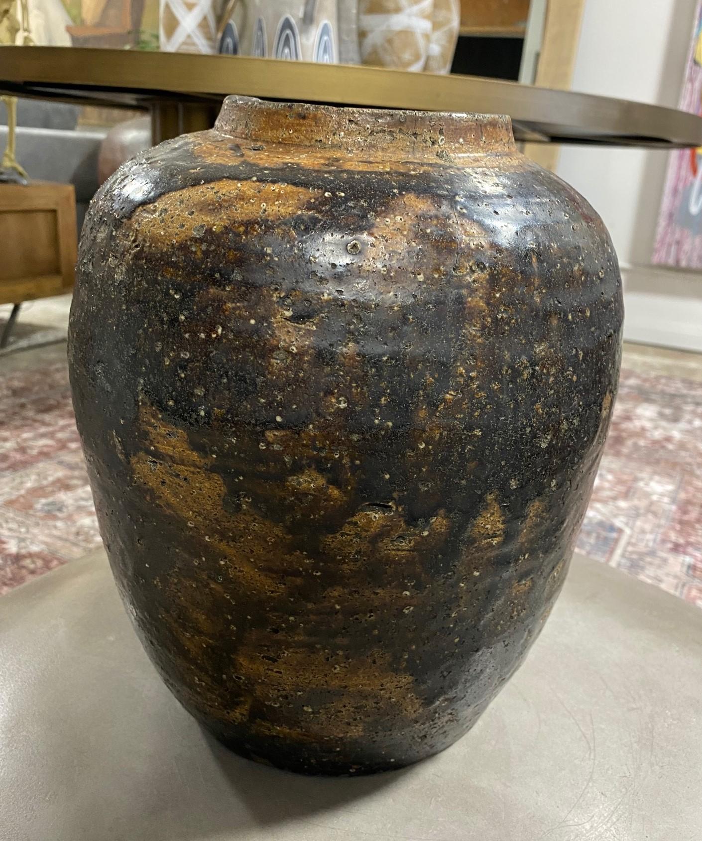 A wonderfully shaped gorgeously iron glazed stoneware Shigaraki tsubo jar vase - truly a stunning and unique work. The natural, organic glaze and tactile textures radiate in the light. We have not seen another with this glaze and pattern. This is a