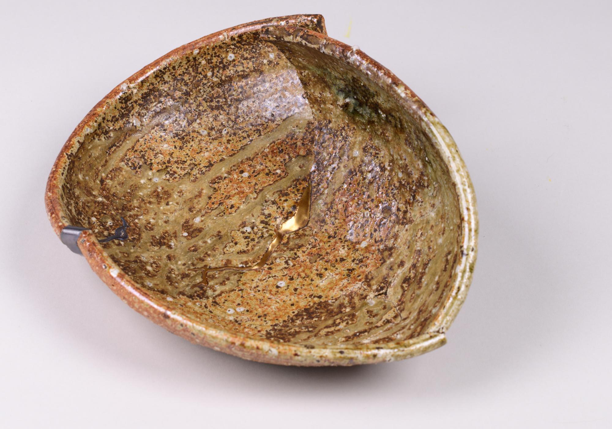 Shigaraki is one of the six ancient kilns of Japan (said to have been established in the 8th century), and is known for its stoneware ceramics. This plate was split intentionally as part of the design, but the artist filled the splits with silver