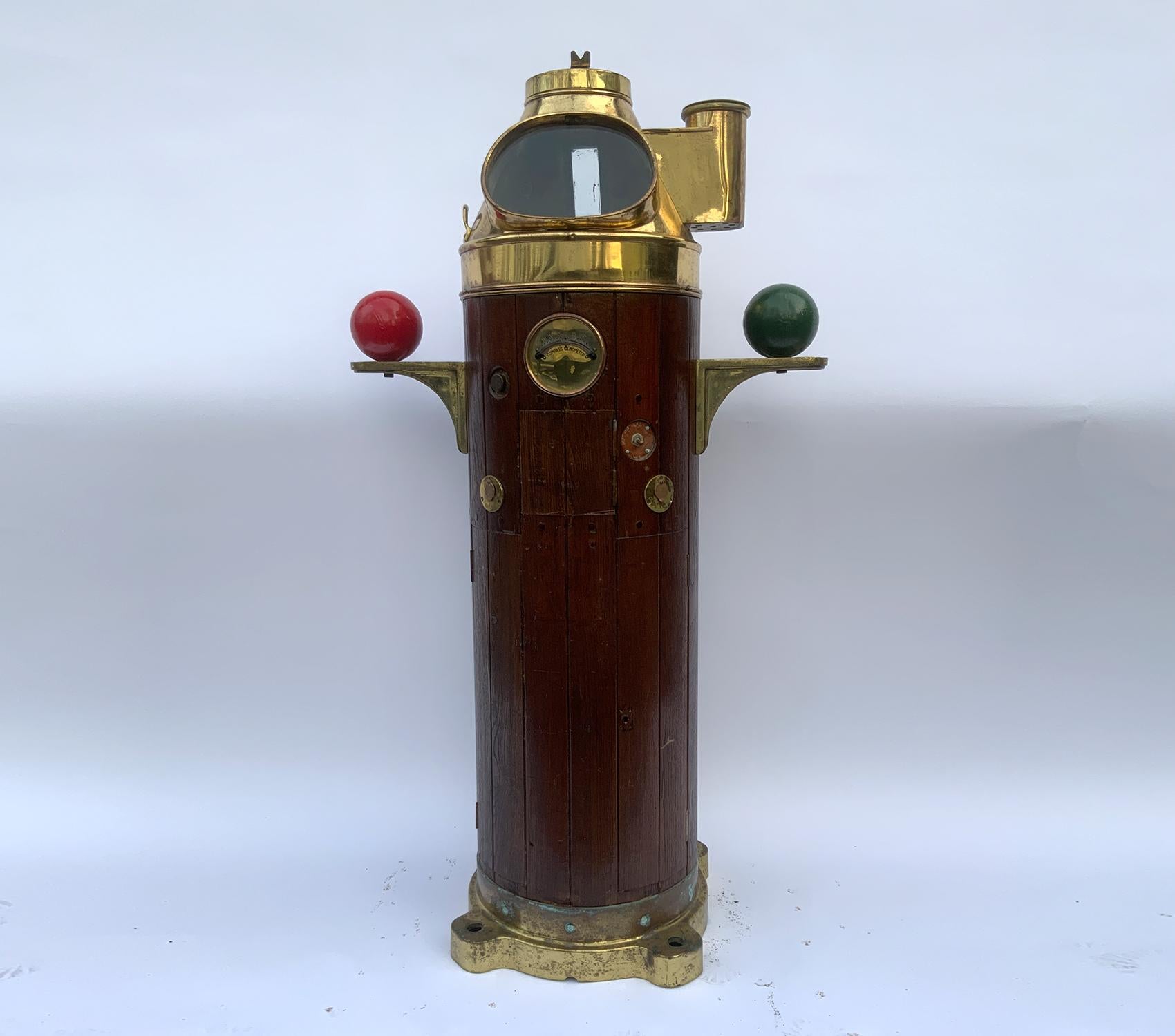 Ships binnacle with gimballed compass by Nunotani Keiki Seisakusho of Amagasaki Japan. Teak binnacle has a heavy brass collar at base. Compass is mounted to base and is fitted with a brass hood with large viewing port. Clinometer on front. Iron