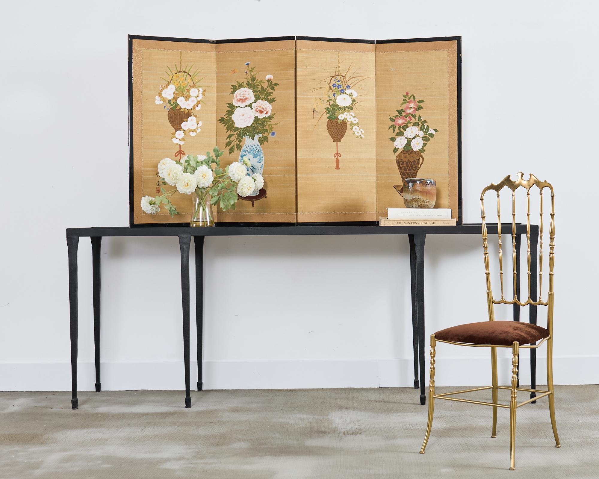 Charming Japanese four-panel Showa period byobu screen depicting colorful floral arrangements in various vases and baskets. The hand-painted screen features vibrant natural color pigments painted on a gilt silk ground. Signed by artist Teien with a