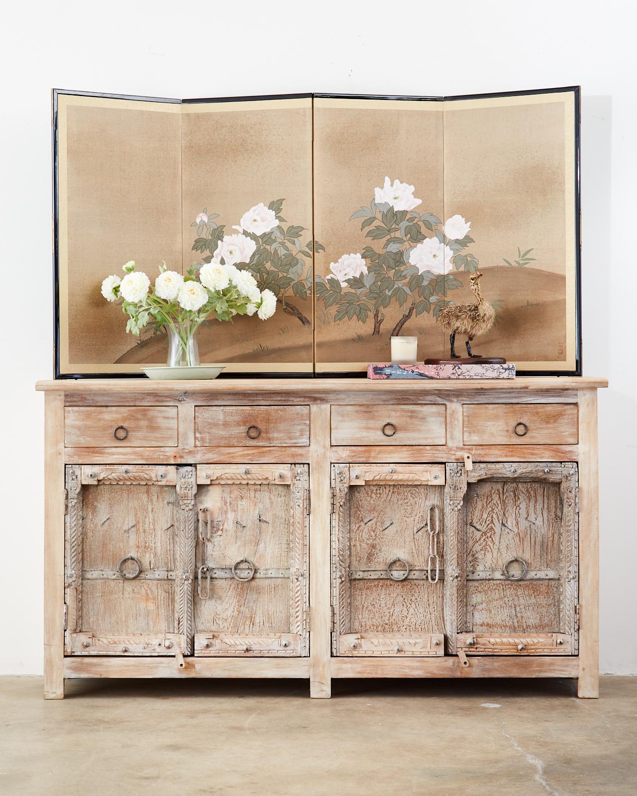 Lovely Japanese Showa period four-panel screen depicting white flowering peonies. Made in the Nihonga school style with ink and color pigments on gilt paper. The scene is decorated with gold flecks. Signed on bottom right side with two seals.