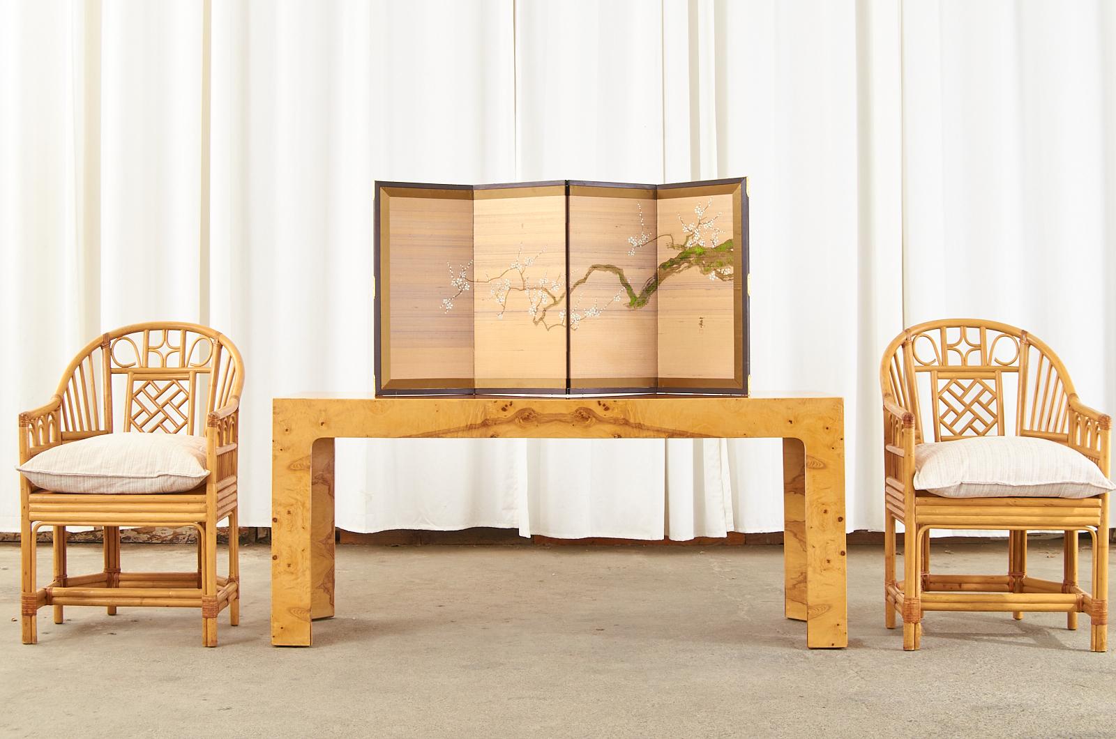 Diminutive Japanese Showa period four-panel folding byobu screen featuring a spring blossoming prunus tree. Ink and natural color pigments painted on silk with a gilt silk border. The painting is signed Ichiju/Kazutoshi on the right side with seal