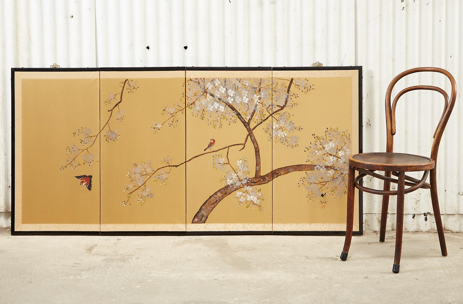 Attractive Japanese Showa period four-panel byobu screen featuring a pair of songbirds amid spring flowering cherry blossoms (Sakura). Ink and natural color pigments on a dramatic gilt ground. Signed with artist seal on the bottom right side. Set in