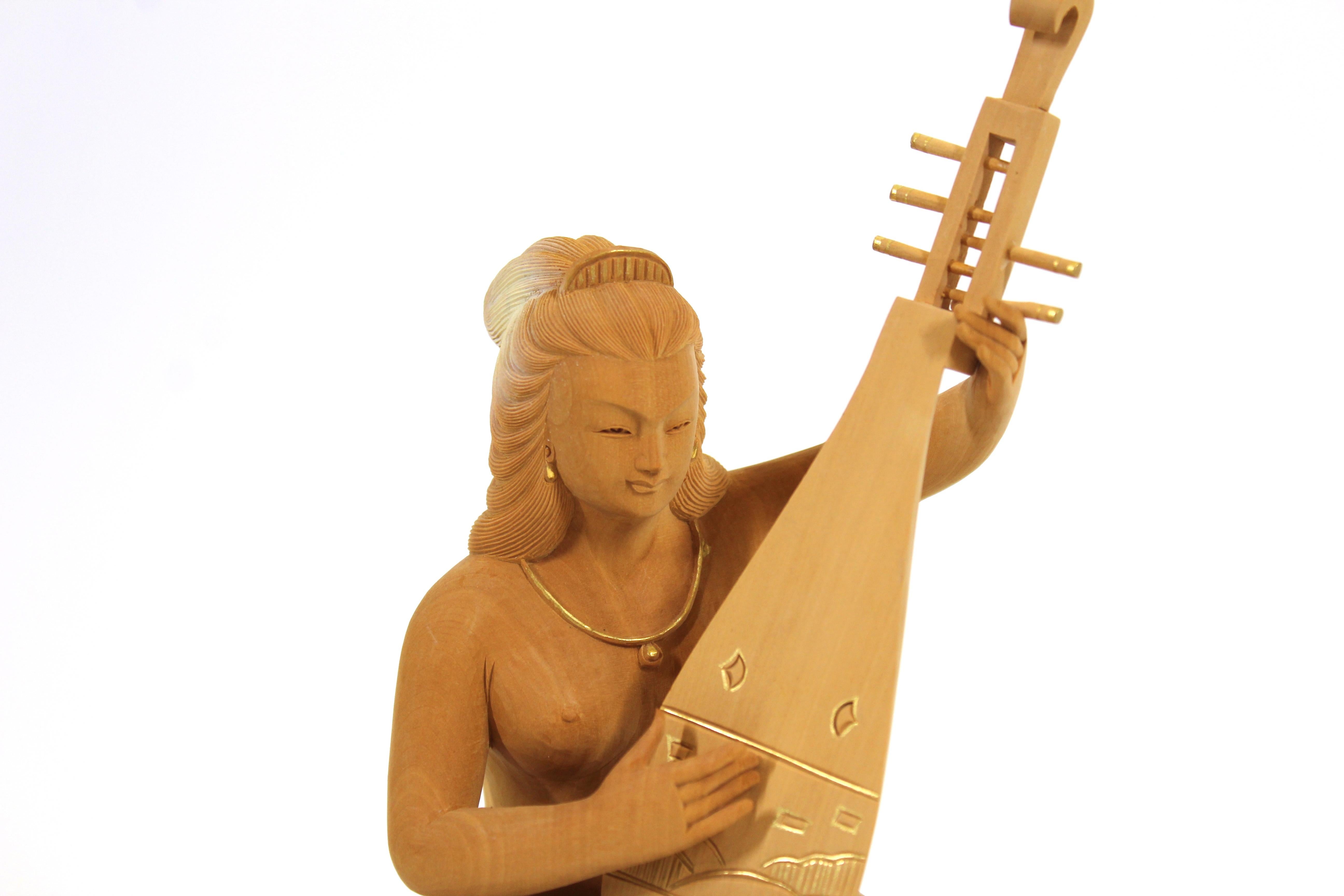 Japanese Heisei period wood carved okimono of a shunga lady playing a Biwa. Made during the Heisei period in circa 1990, the piece remains in remarkable vintage condition with age-appropriate wear.