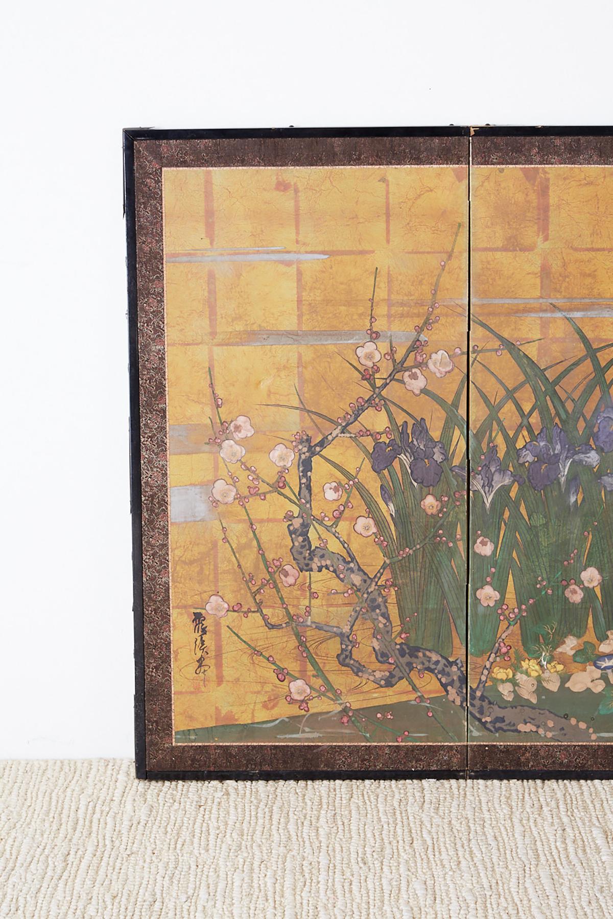 Captivating Japanese Showa four-panel byobu screen depicting a floral and foliate scene. Interesting style in which the artist has created a painting with an aged and distressed patina. Having a faux-gilt square painted background and flowers with a