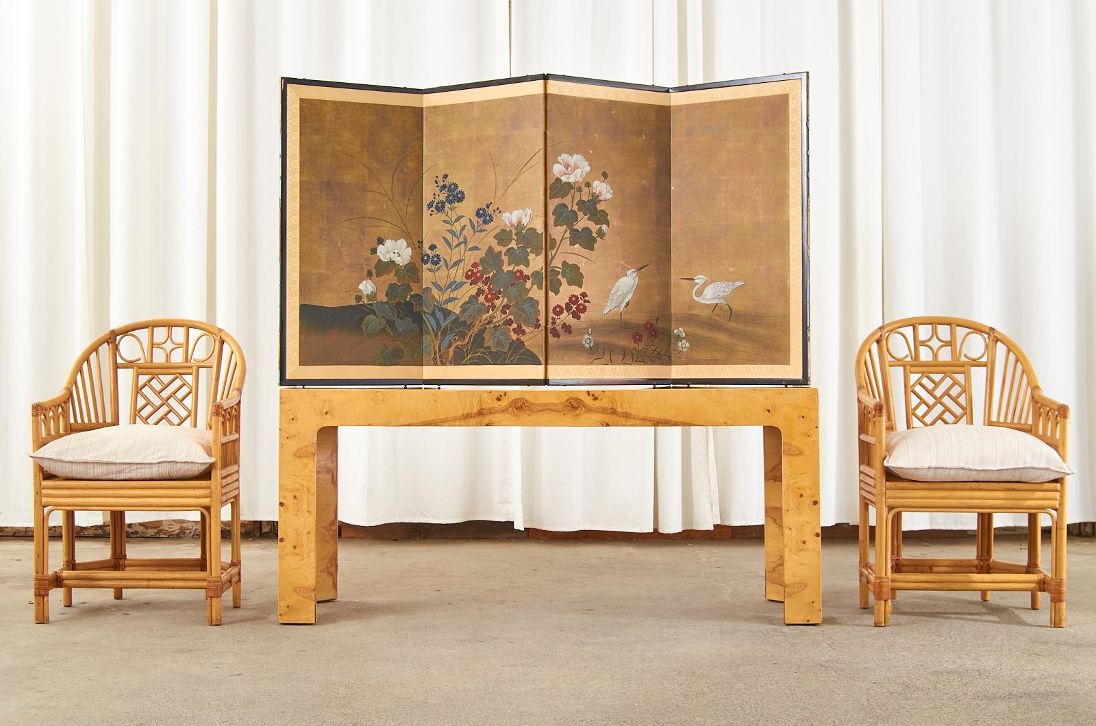 Signed Japanese Showa period four-panel folding byobu screen featuring colorful chrysanthemums and hibiscus flowers with two egrets. Ink and color pigments on gilt paper signed by artist Sankei with a seal. Set in a lacquered frame with a garden