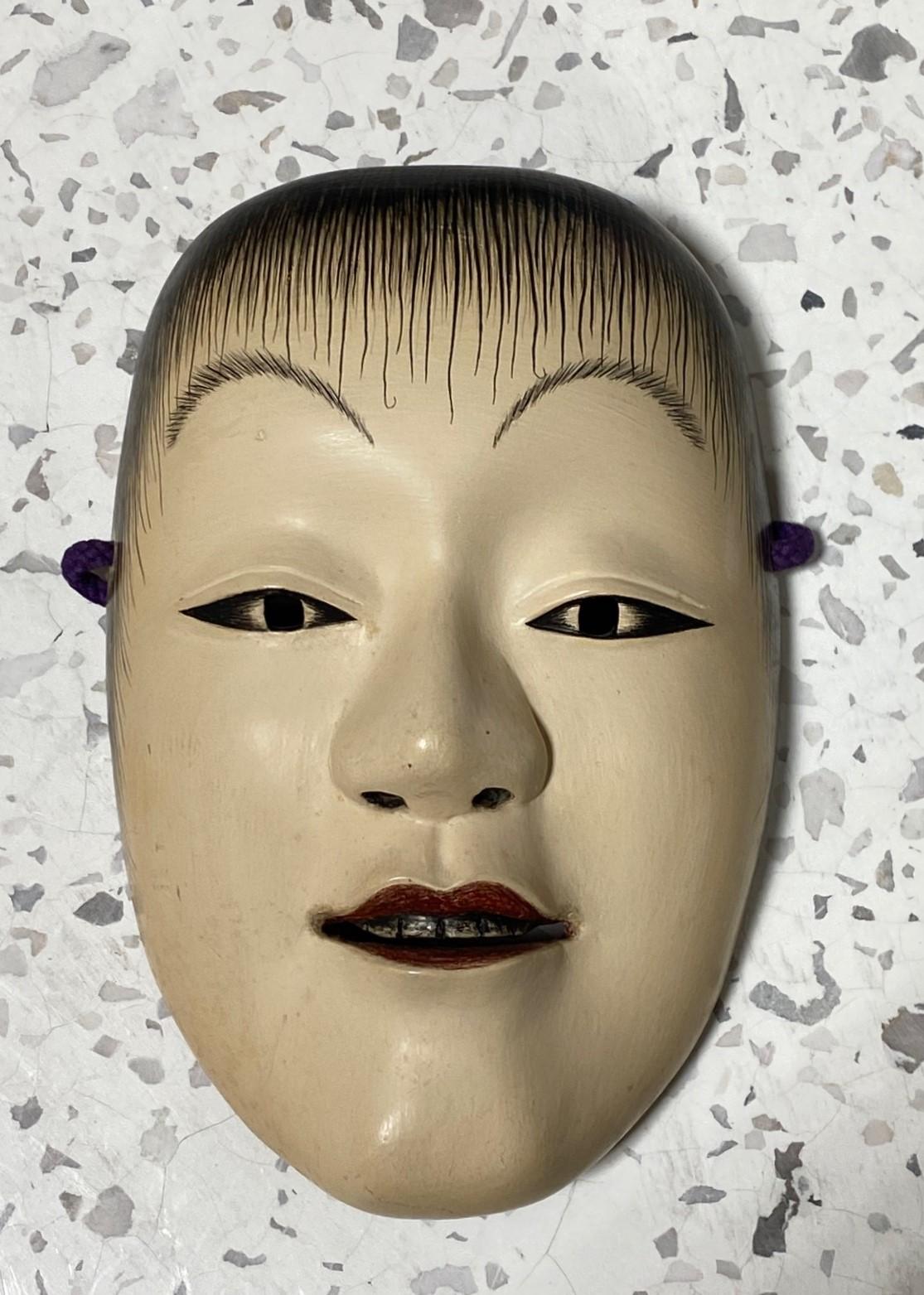 A beautiful, wonderfully crafted, alluring mask made for Japanese Noh theatre.

The mask is handcrafted and hand-carved from natural wood and is signed by the maker. 

This mask is of the immortal character Doji who symbolizes perpetual and eternal