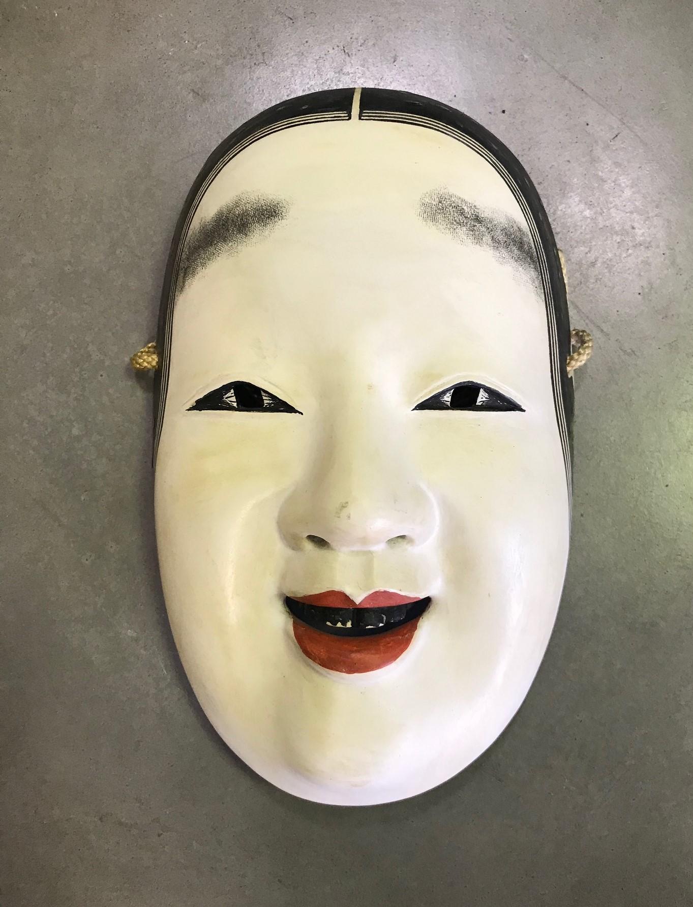 A truly beautiful, intricately detailed, alluring mask made for a Japanese Noh theater actor.

This well done, high class mask is handcrafted and carved from natural wood. The artisan's signature can be seen on the verso. 

Ko-omote translates