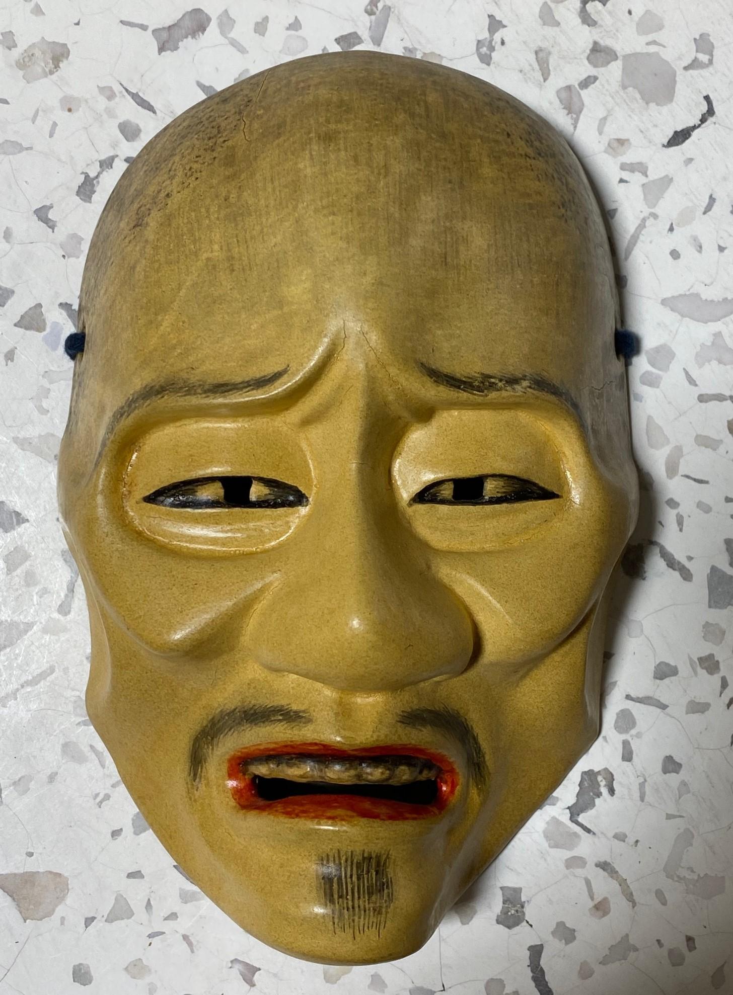 A beautifully carved, wonderfully crafted, highly engaging mask made for Japanese Noh theatre.

The mask is handcrafted and hand carved from natural wood and is signed and sealed by the maker, clearly a master of his Craft, on the verso. 

This