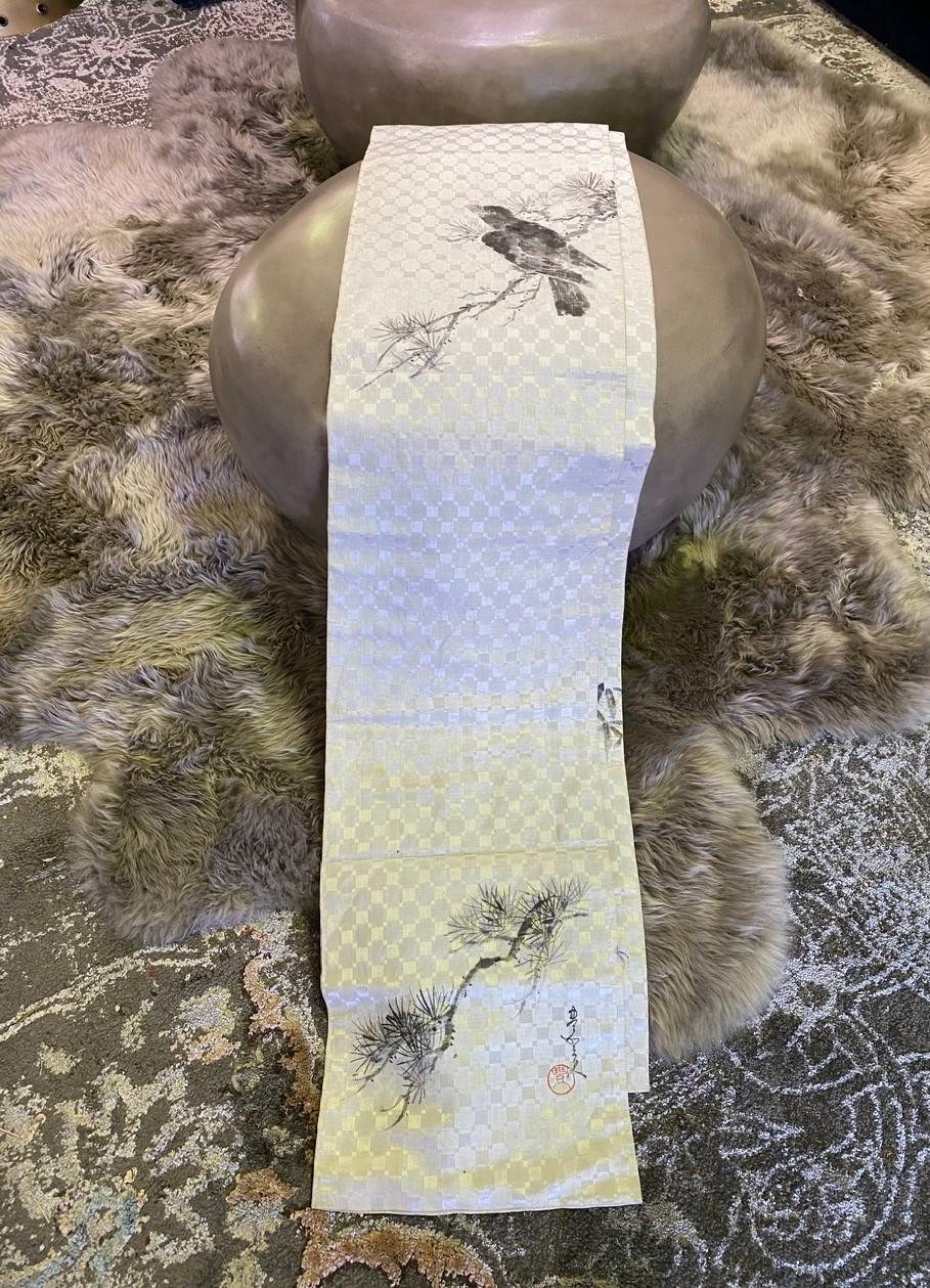A wonderful handmade vintage silk Obi sash/ belt featuring a rather unique hand-drawn scene with a crow and trees.

Signed and stamped by the artist. 

Would be a fantastic addition to any collection or stand-alone accent piece - perhaps as wall