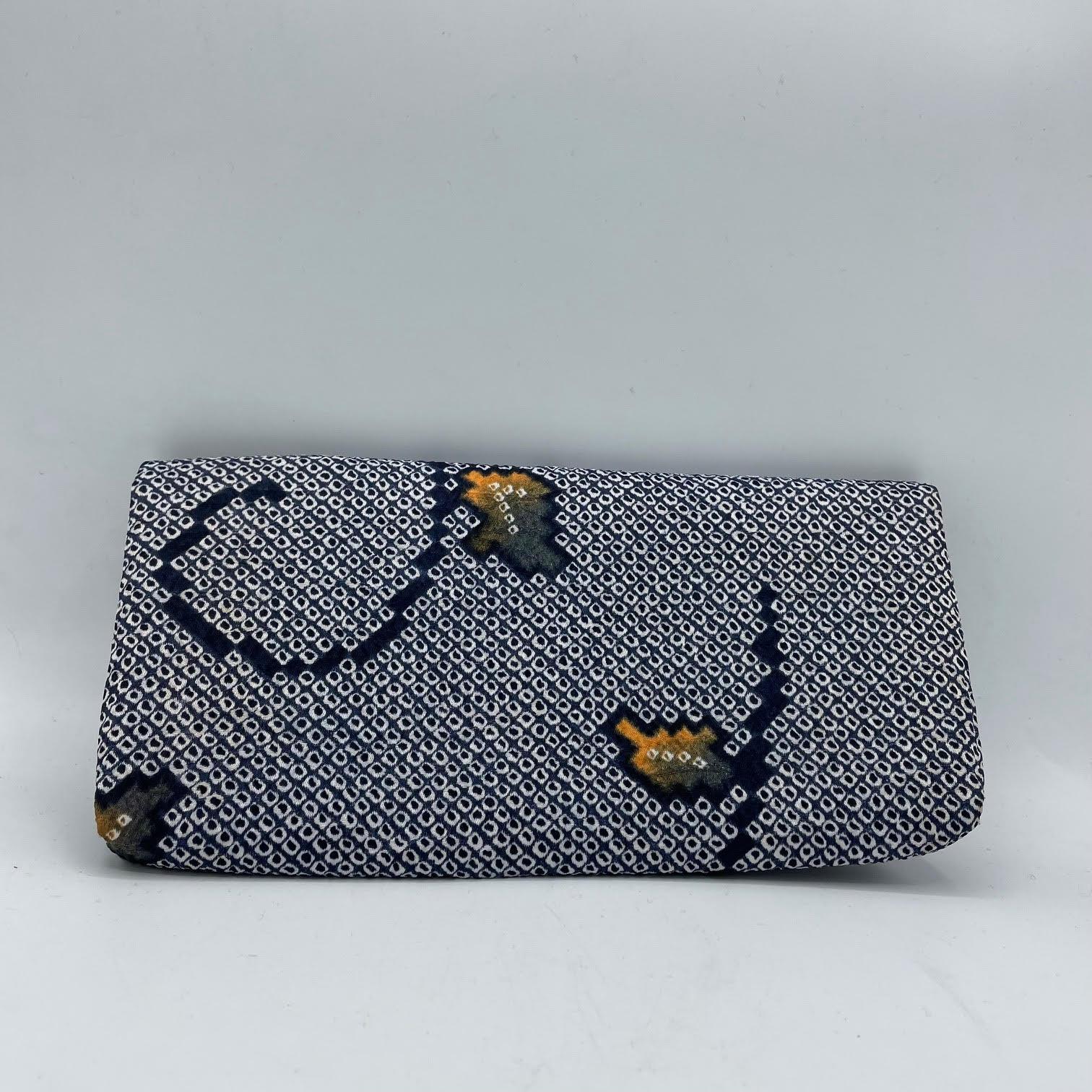 This is a hand bag which was made in Japan around 1990s.
This bag's material is Silk and it is made with Shibori technique.

Dimension: 24.5 × 12.5 × 2.5 cm 

*Shibori is a traditional Japanese tie-dye technique used to create patterns on