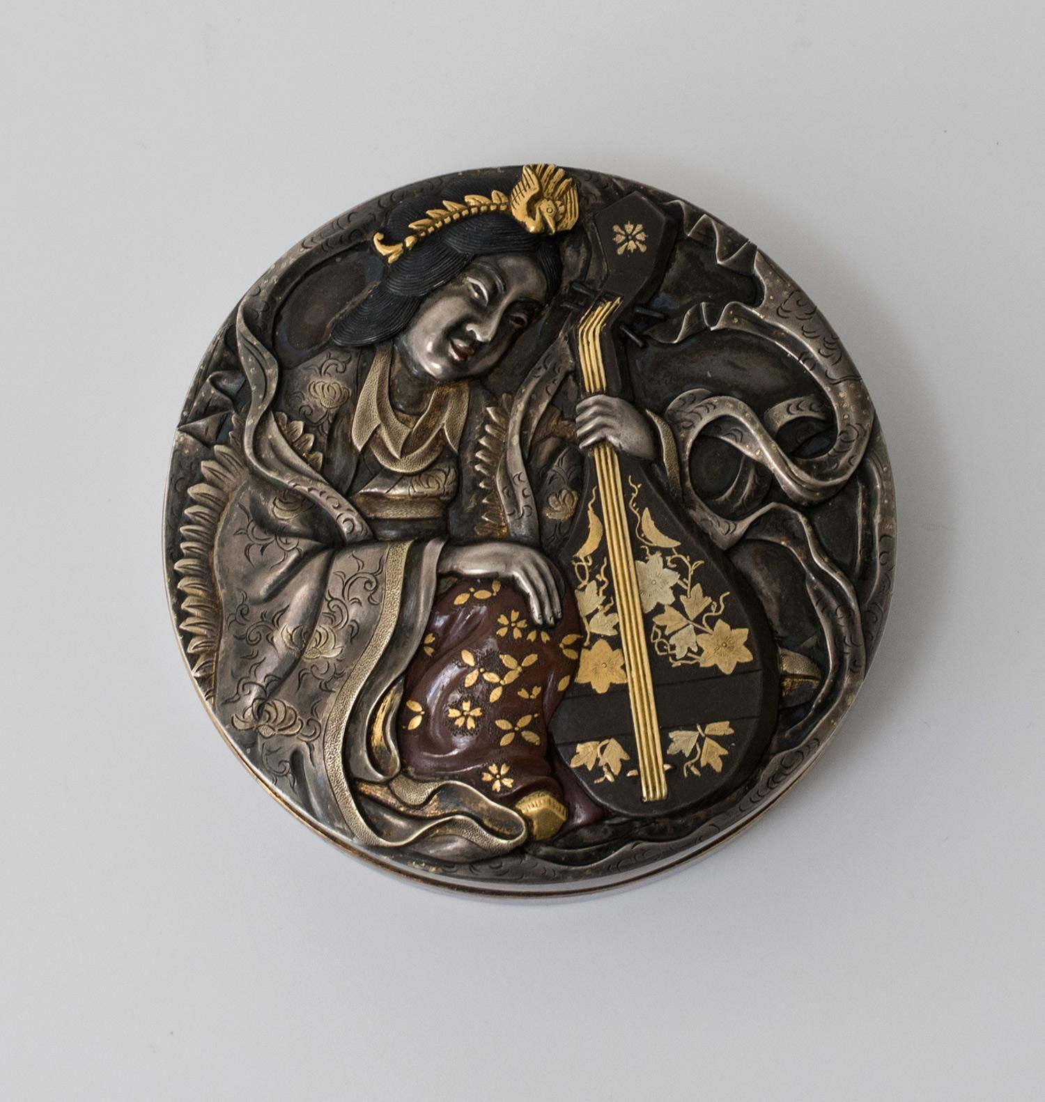 As part of our Japanese works of art collection we are delighted to offer this charming Meiji Period 1868-1912, circular lidded box (Kogo) depicting the only female representation of the seven lucky gods, Benzaiten , also known as Benten. The artist