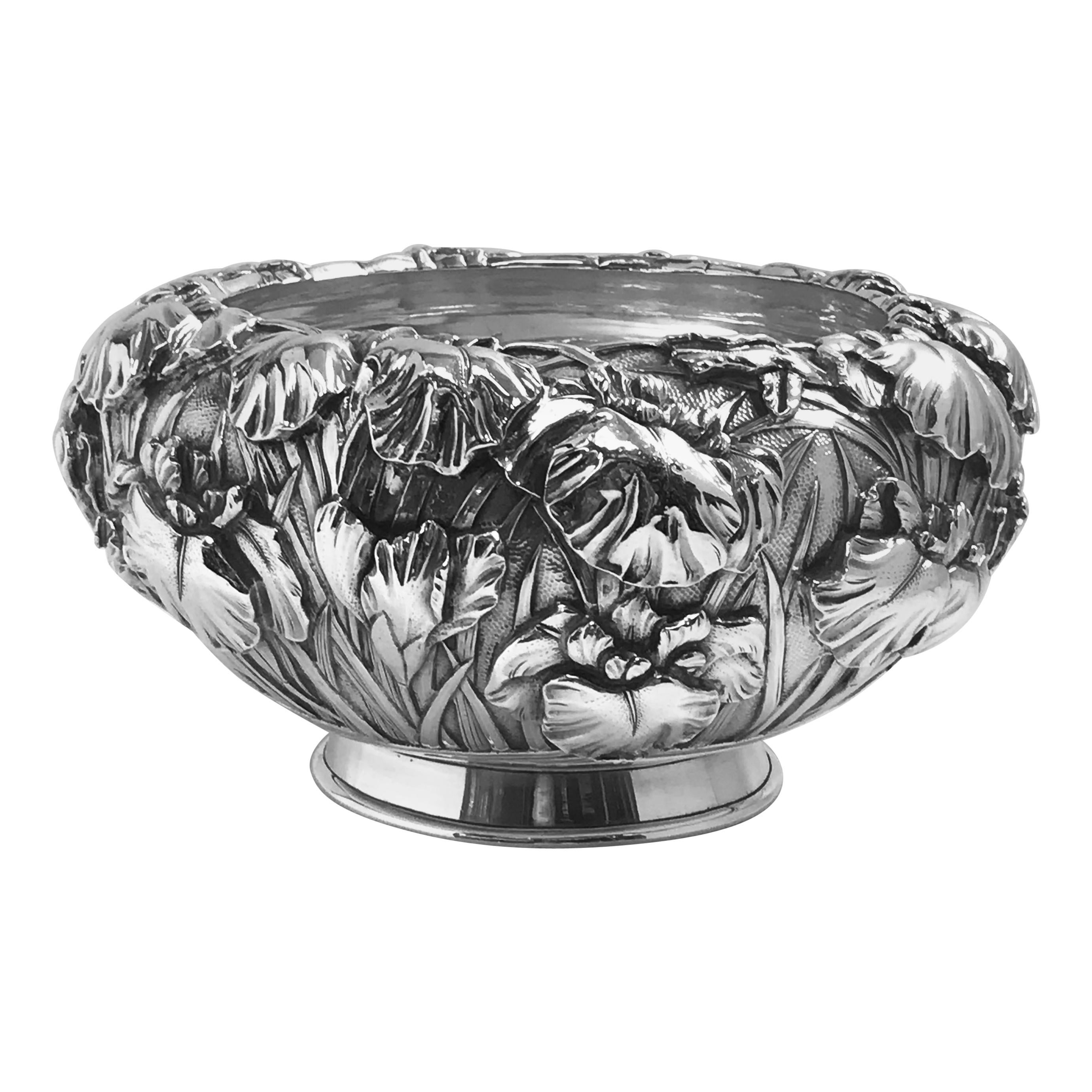 A fine Japanese silver bowl from the Meiji period of traditional double-skin, or double-wall, construction, showing especially detailed irises around the outside and with a smooth, plain interior. The base has the 