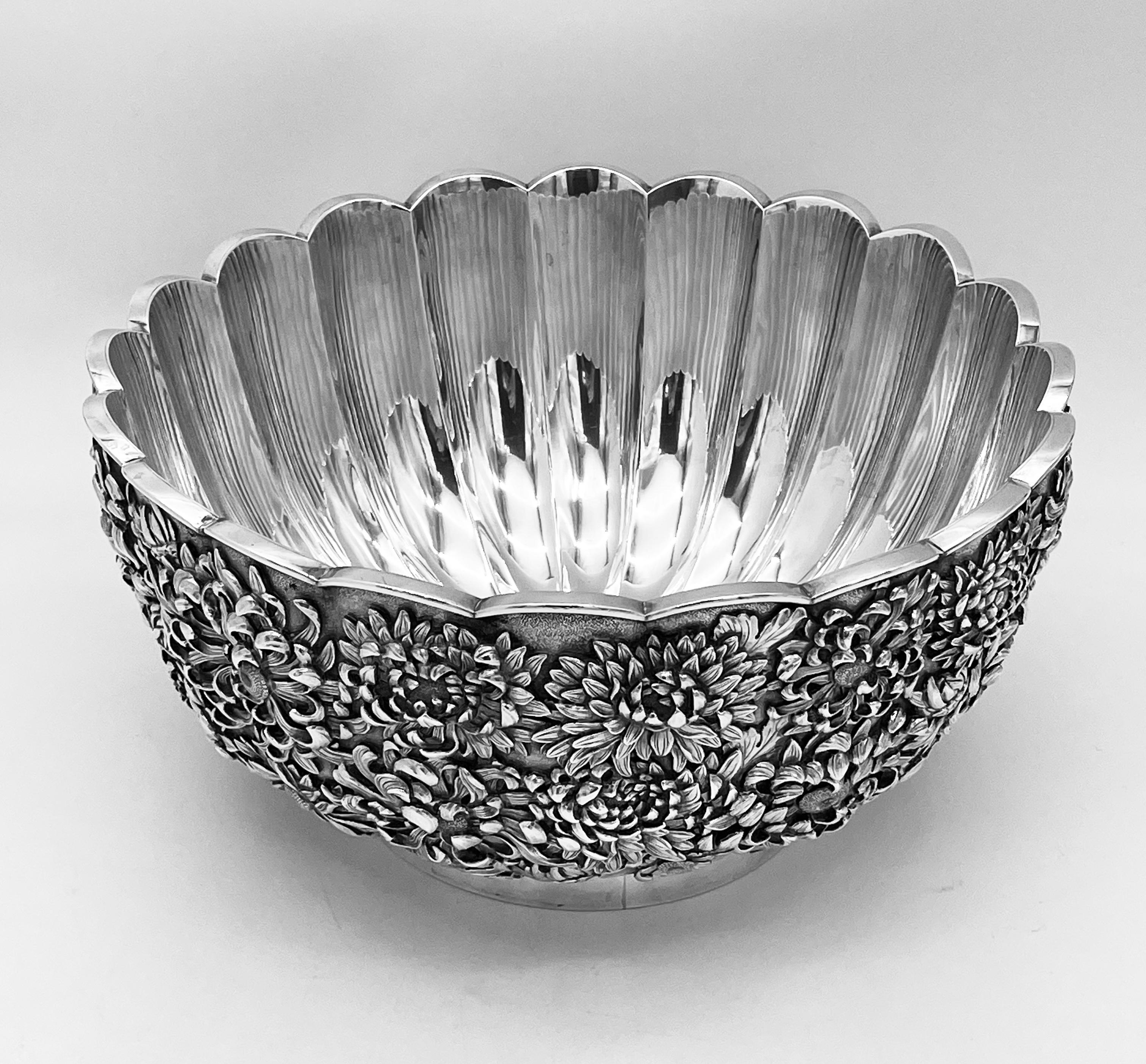 A large, fine late 19th or early 20th century Japanese Silver Bowl, with the mark of Yoshikatsu of Yokohama.

The bowl from the Meiji period, is of hemispherical form with scalloped rim upon a plain round foot. The exterior is profusely embossed