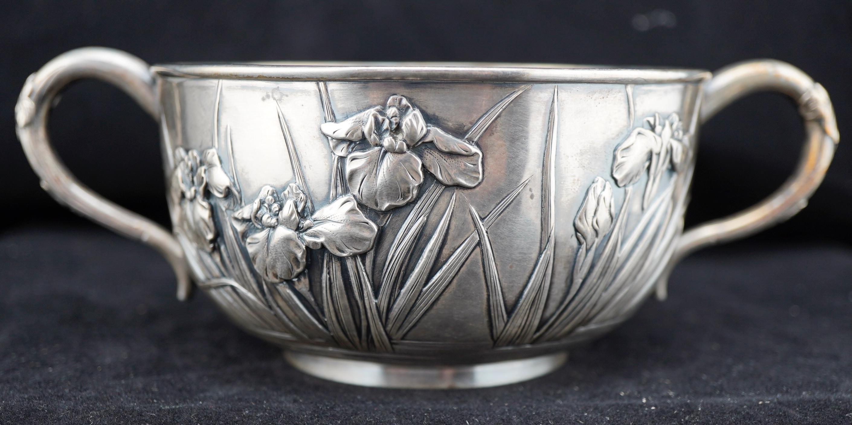 Japanese silver bowl with handles by Konike. Finely decorated with repousse irises and cast floral handles. Marked on the bottom for the maker.
Weight 272 g or 8.7 t.oz
