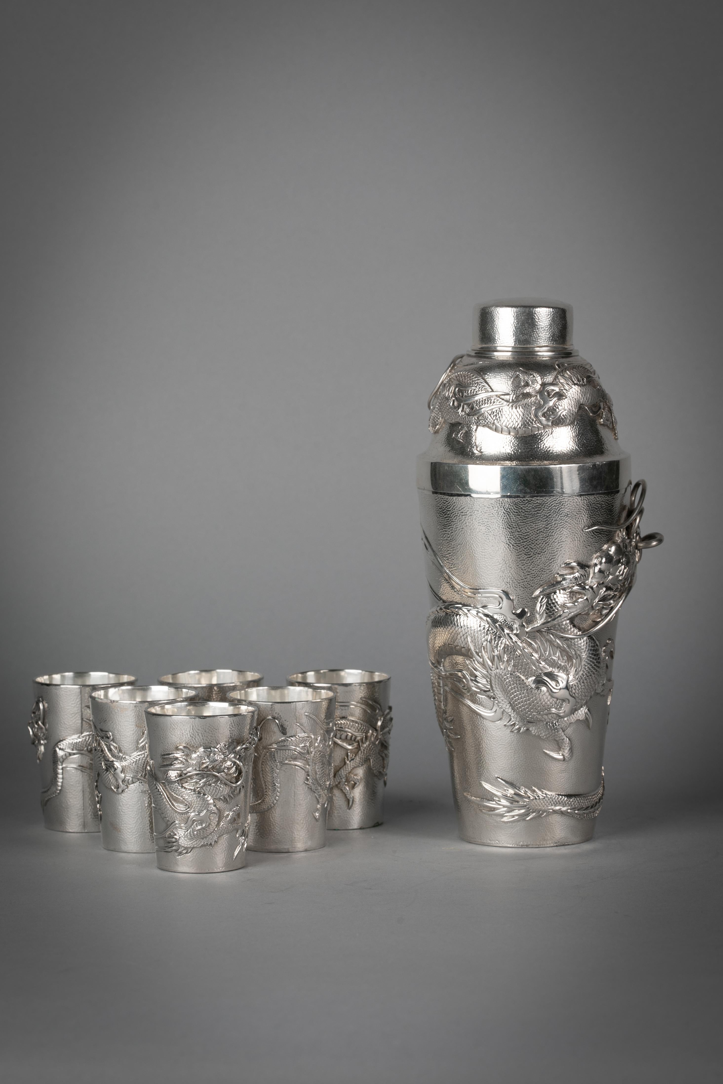 Comprising one cocktail shaker and six shot glasses. Marked 