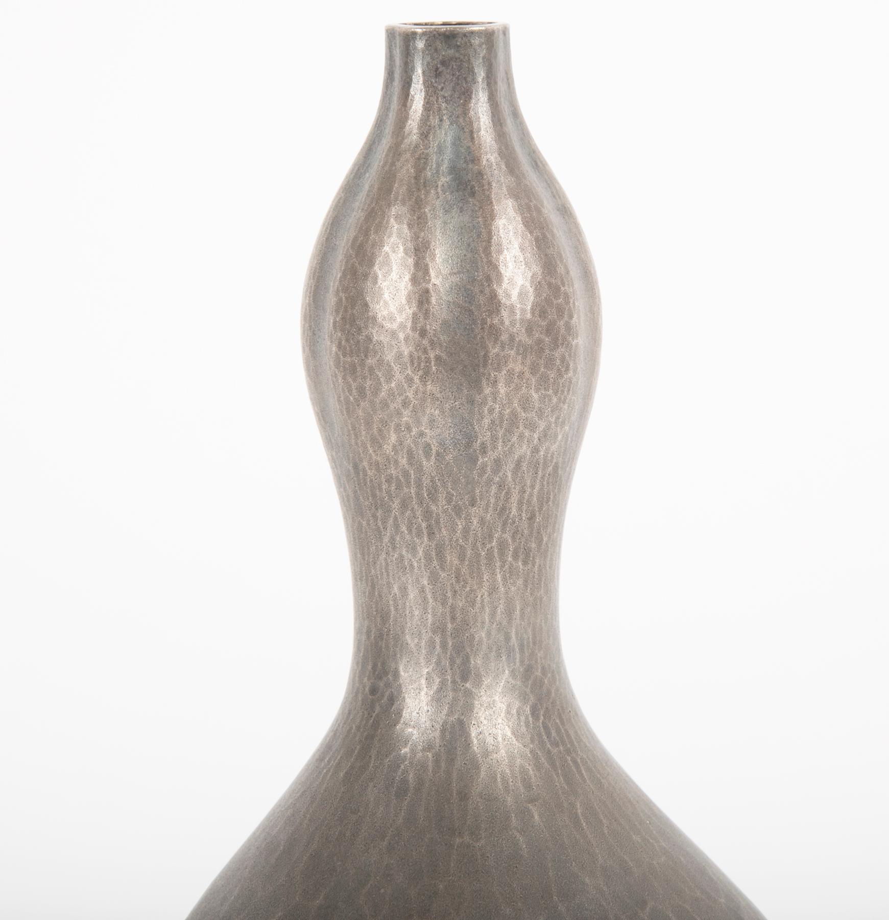 A Japanese silver double gourd vase with a matt, hand-hammered grey and silver patina. Attributed to Hirata Munemichi. Unsigned with wooden storage box. Stamp on base, 