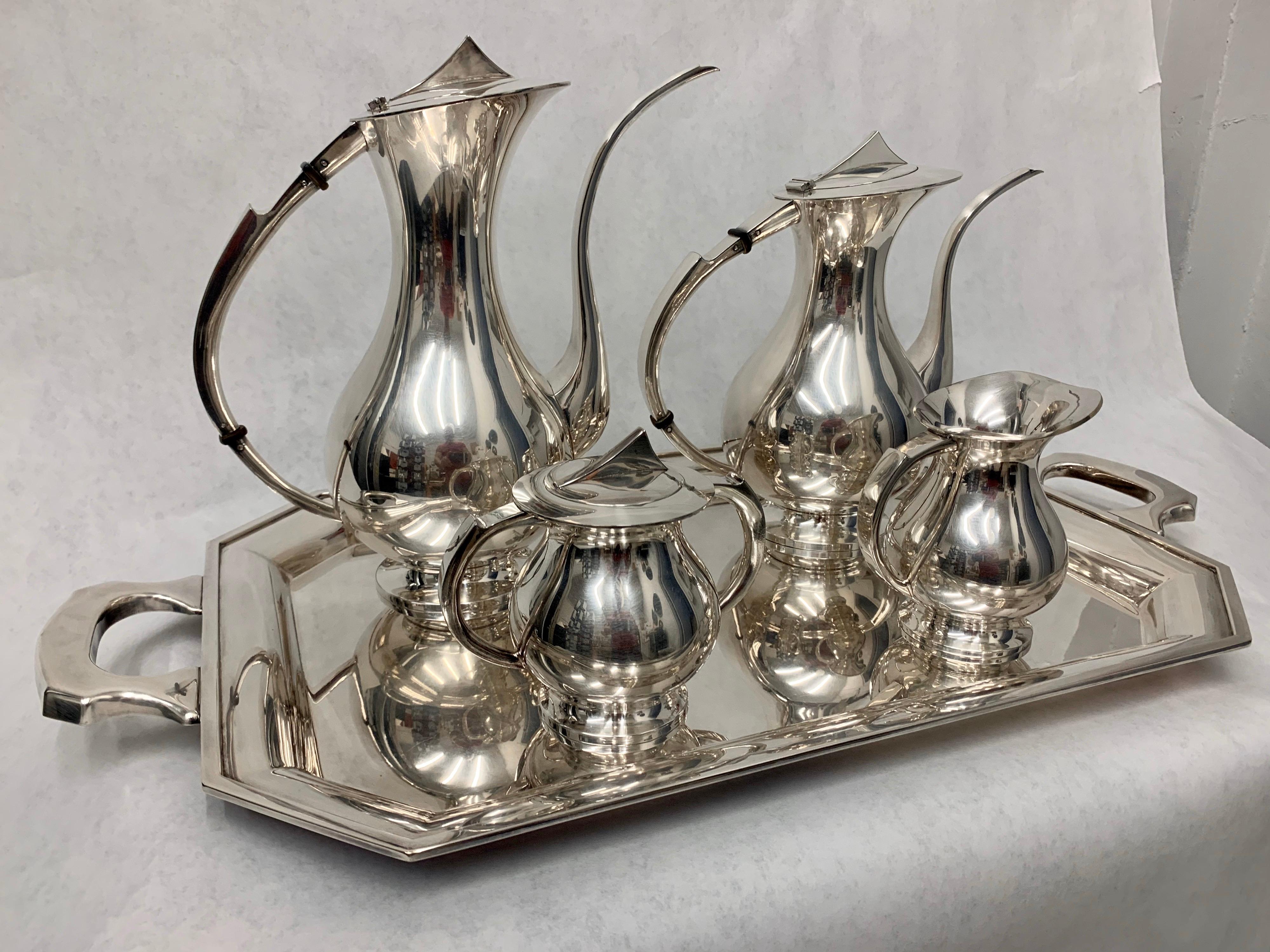 Japanese silver plated 5-piece coffee or tea set
Dimensions:
Serving tray, 26.5 wide, 14.5 deep, 1 inch tall
Larger coffee pot, 11.75 inches tall, 12.5 deep, 5.5 wide
Smaller tea pot, 10 inches tall, 11.5 deep, 5.5 wide
Creamer, 5.25 tall, 5,25