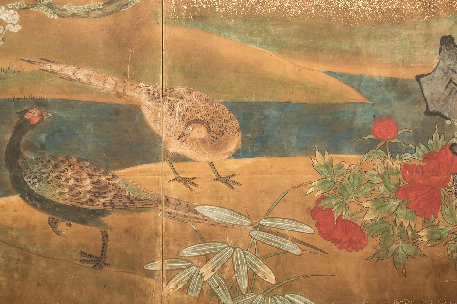 Japanese six-panel screen: waterfall and cherry in Audubon landscape, Edo period painting, 18th century, depicting summer and spring. A Kano School painting executed in mineral pigments on paper with gold dust and a silk brocade border.