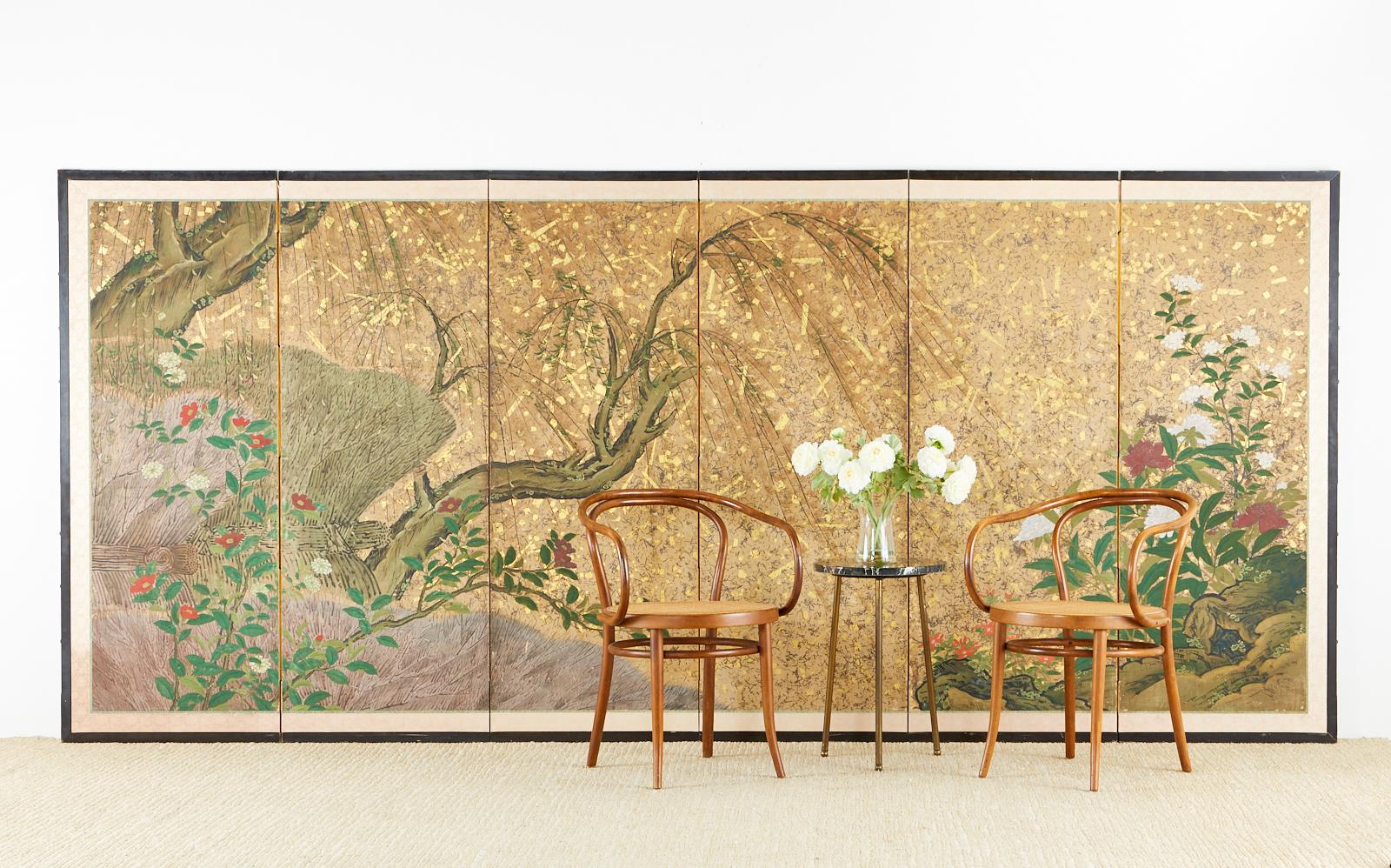 18th century Japanese Edo period six-panel screen featuring spring willow with camellia and peonies in a dramatic storm of silver and gold leaf flecks. Made in the Hasegawa school style with various sizes of silver and gold flecks appearing like a