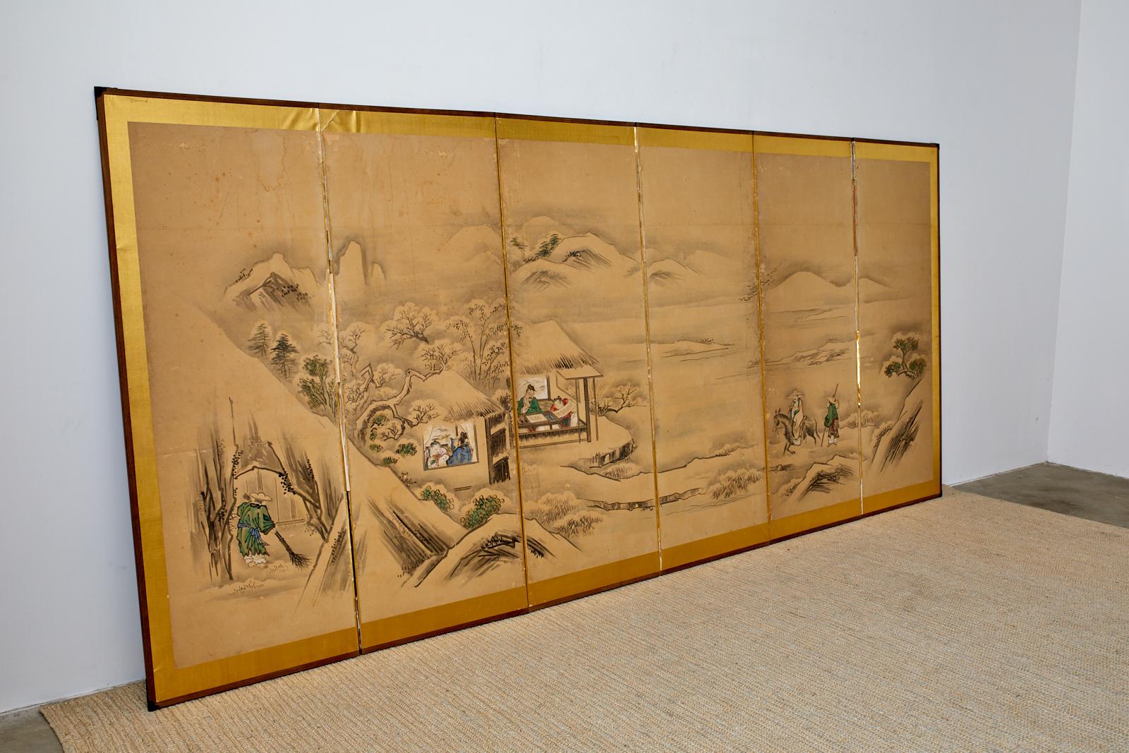 Large Japanese Meiji period six-panel screen depicting a winter landscape with a Chinese sage visiting friends in a country villa. Ink and vivid color pigments on mulberry paper mounted to a gilt background. Painted in the 19th century Kano school