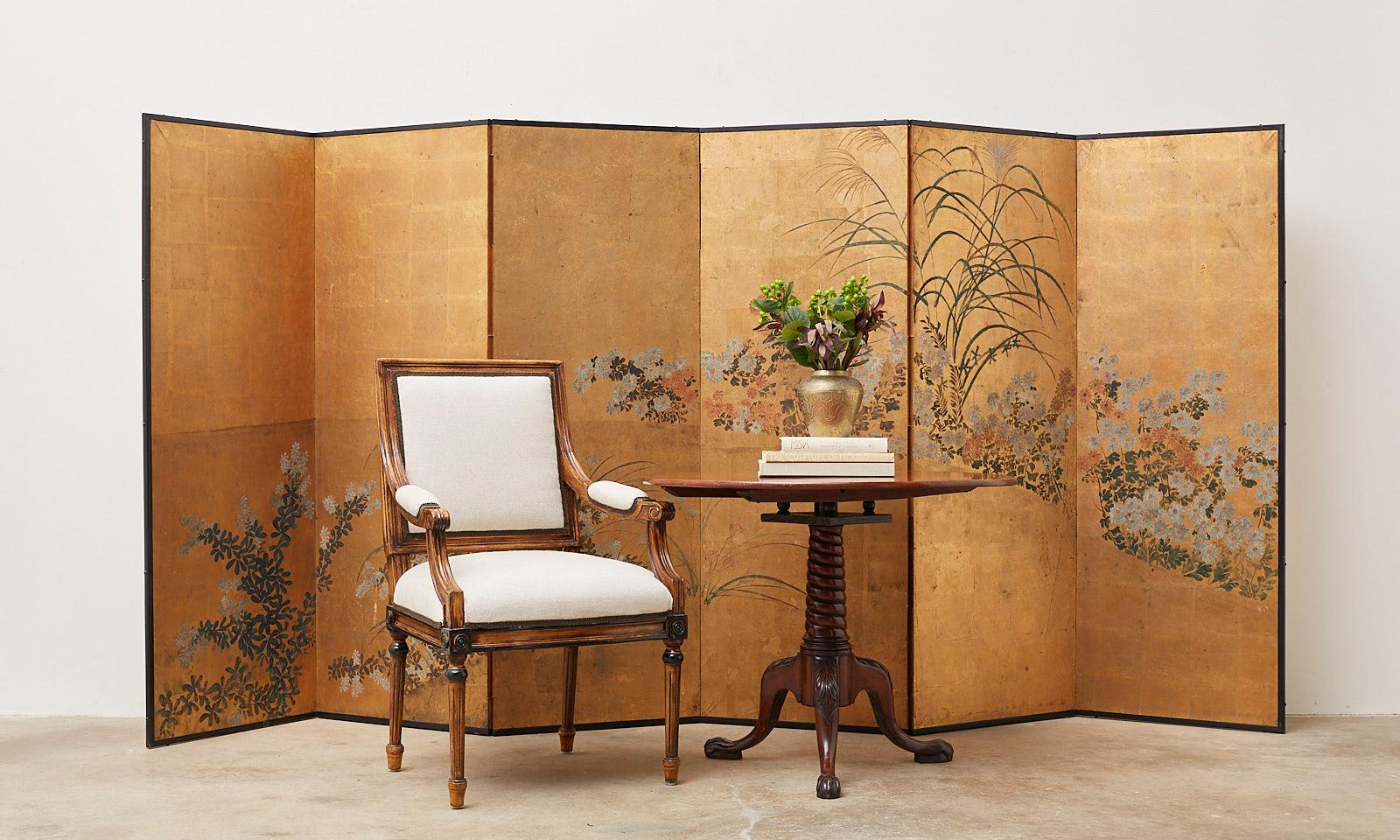 Impressive Japanese six-panel Meiji period screen made in the Rinpa school style after Tawaraya Sosetsu (1570-1640). Depicting autumn flowers, plants, and grasses of bush clover, chrysanthemum, and pampas grass (hagi, kiku, and obana). Ink and color