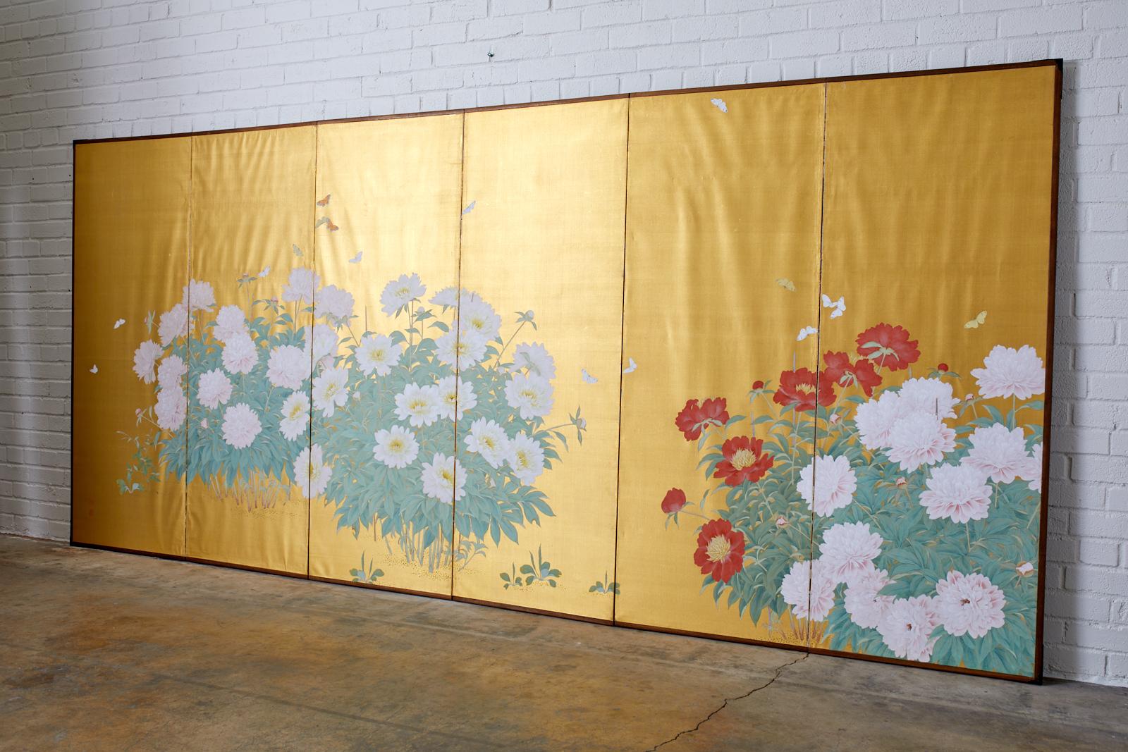 Stunning Japanese Meiji period six-panel large screen. Featuring blooms of spring flowering white, pink, and red peonies with butterflies over a gilt background. Made in the Nihonga school style with ink and color pigments on gilt. Two artists seals