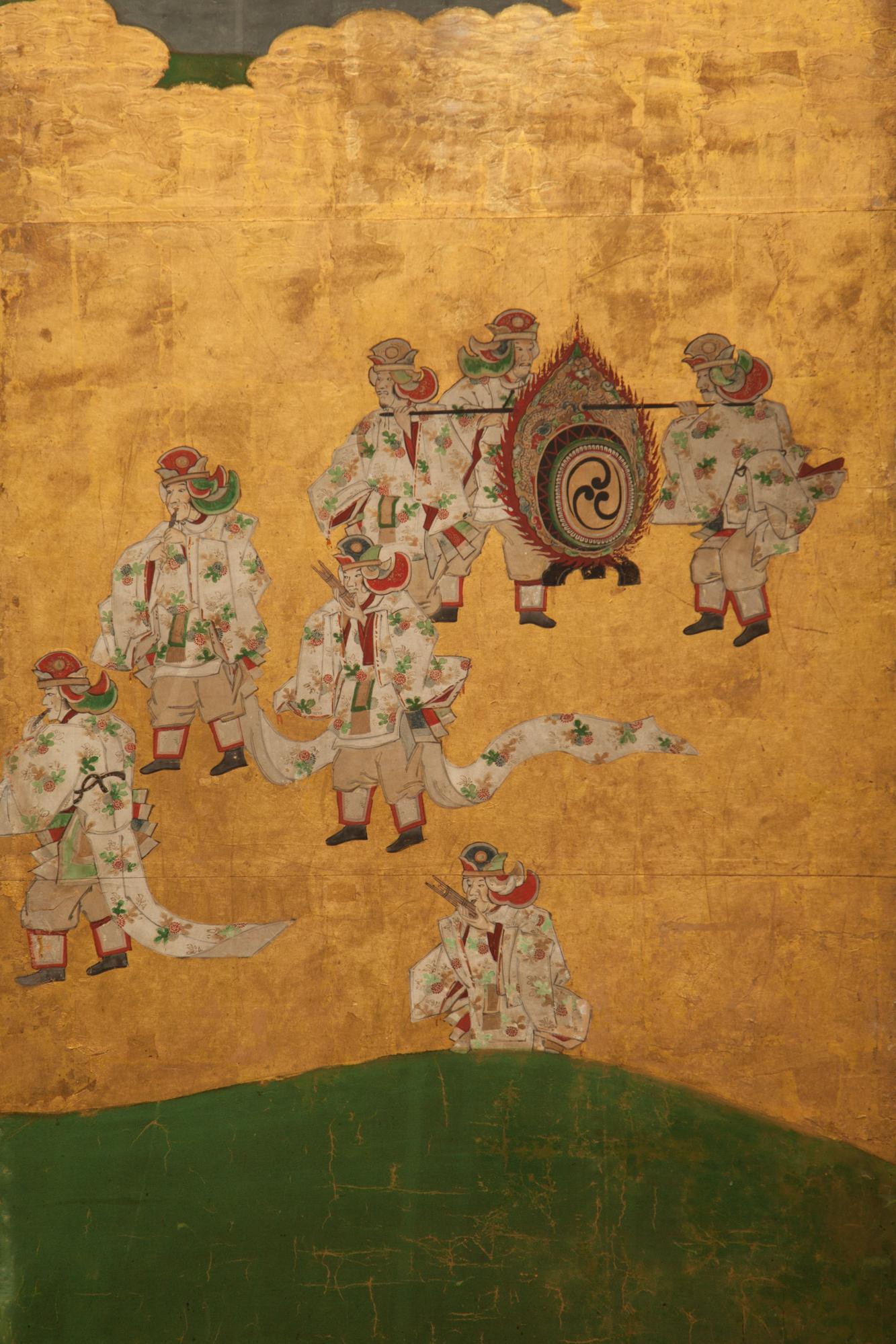 Courtiers are those that are in attendance at a royal court. Beautifuly painted court figures in procession with ancient musical instruments. Tosa School painting in mineral pigments on gold leaf and mulberry paper with silk brocade border.
 