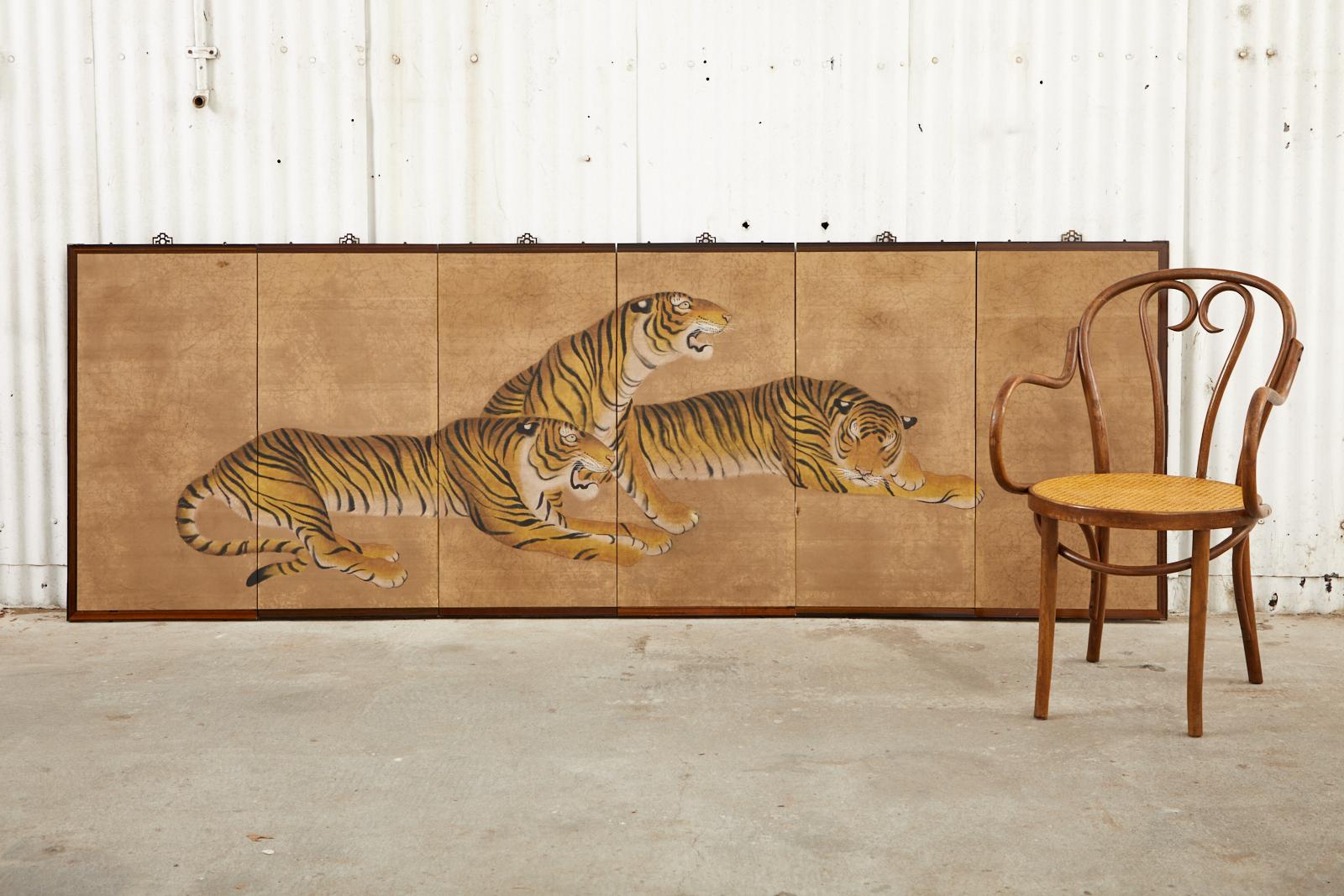 Fantastic Japanese six-panel byobu screen depicting an ambush of three tigers relaxing. The painting is set in a gorgeous hardwood frame with a rich lacquered finish and is very heavy. The image has ink and color pigments over a marbleized