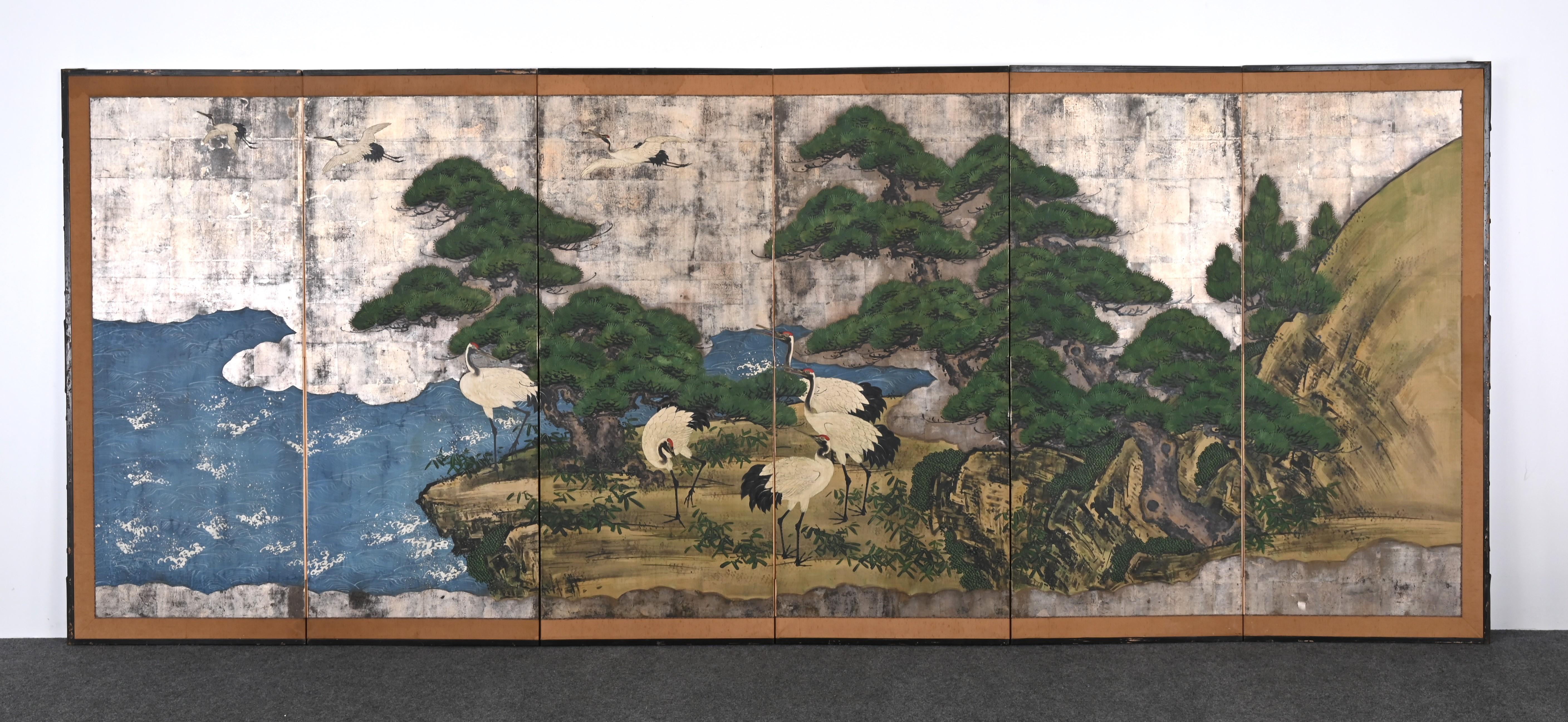 A monumental Asian Six-panel Japanese screen with cranes and foilage along a body of water. This screen is from the Kano School dating between the 18th Century and 19th Century. The panels are painted and silver leaf melted on board. The edges are
