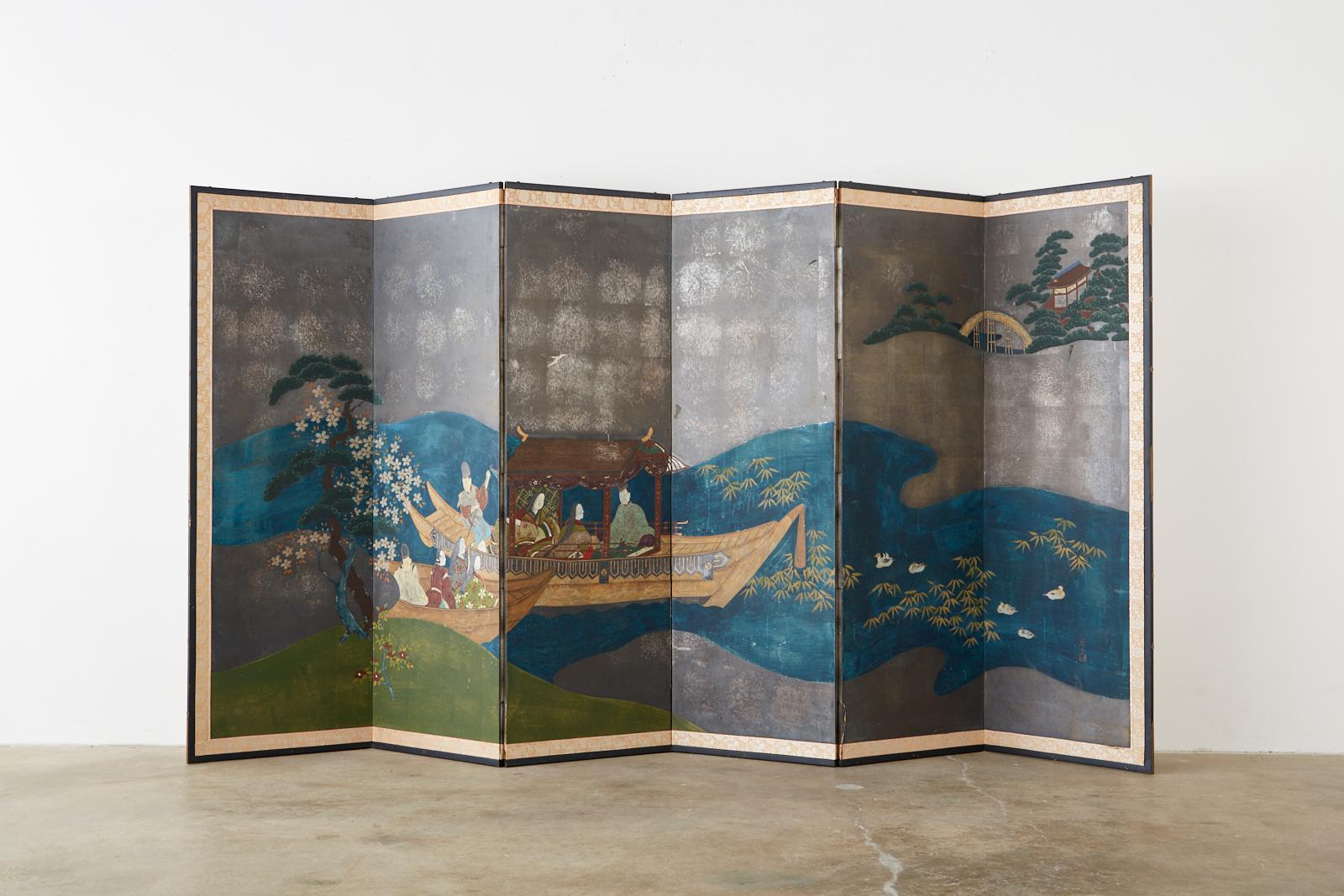Enchanting Japanese six-panel Showa period screen from the court narrative tales of Genji. The colorful screen is centered by deep blue waters over a dramatic faded silver-leaf background with the characters in two boats. Ink and color pigments over
