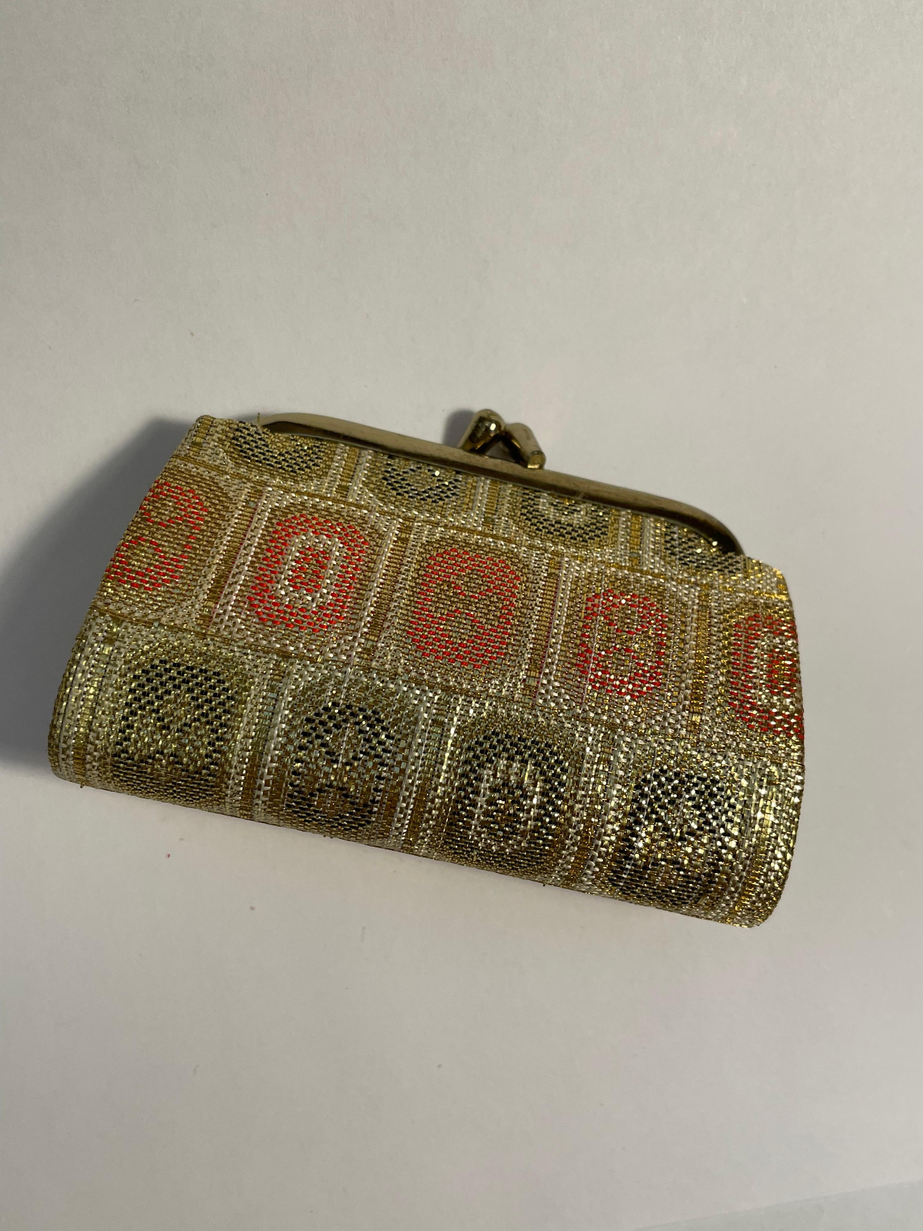 This is a wallet/ coin case which was made in Japan around 1990s.
It is made with silk and this wallet will come with a plastic case.
The material is silk and metal. The technique which they used is called Saganishiki/ Nishijin-ori. 

Saga Nishiki