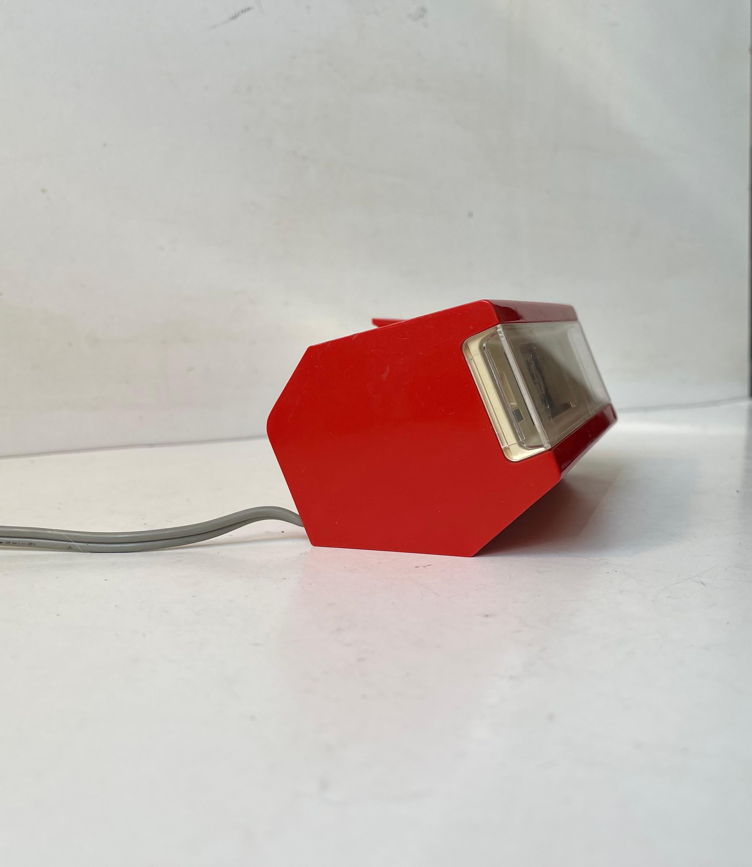 There certainly a vibe of early James Bond to this vintage flip clock from Japanese Copal LTD Co. Design/model number: 109416. It was manufactured in the 1970s and is in working order. It's made from red and cream colored molded plastic featuring a