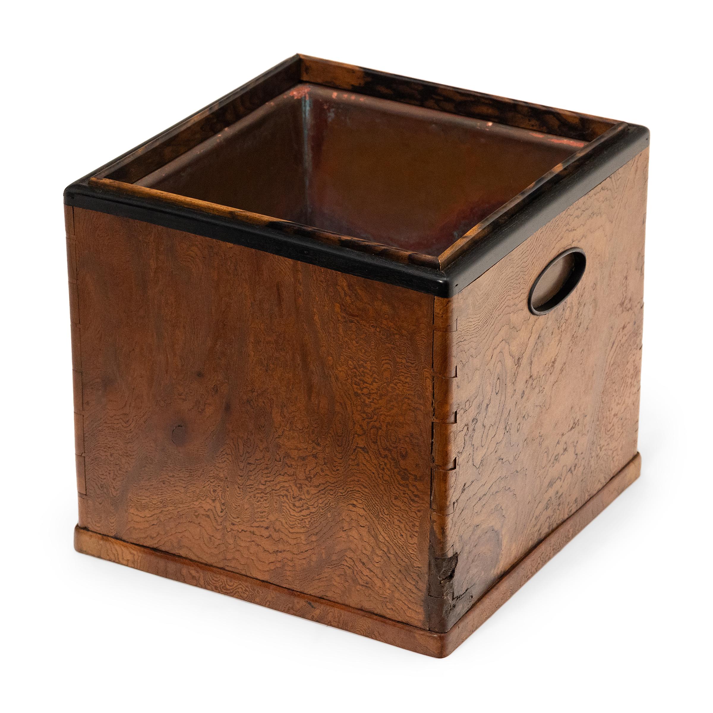 Known as a kaku-hibachi, this container was the center of social life in a Meiji era home. Used to brew tea or heat sake, the kaku-hibachi is a portable form of the traditional hearth. Carefully crafted, the square box is topped with a copper well