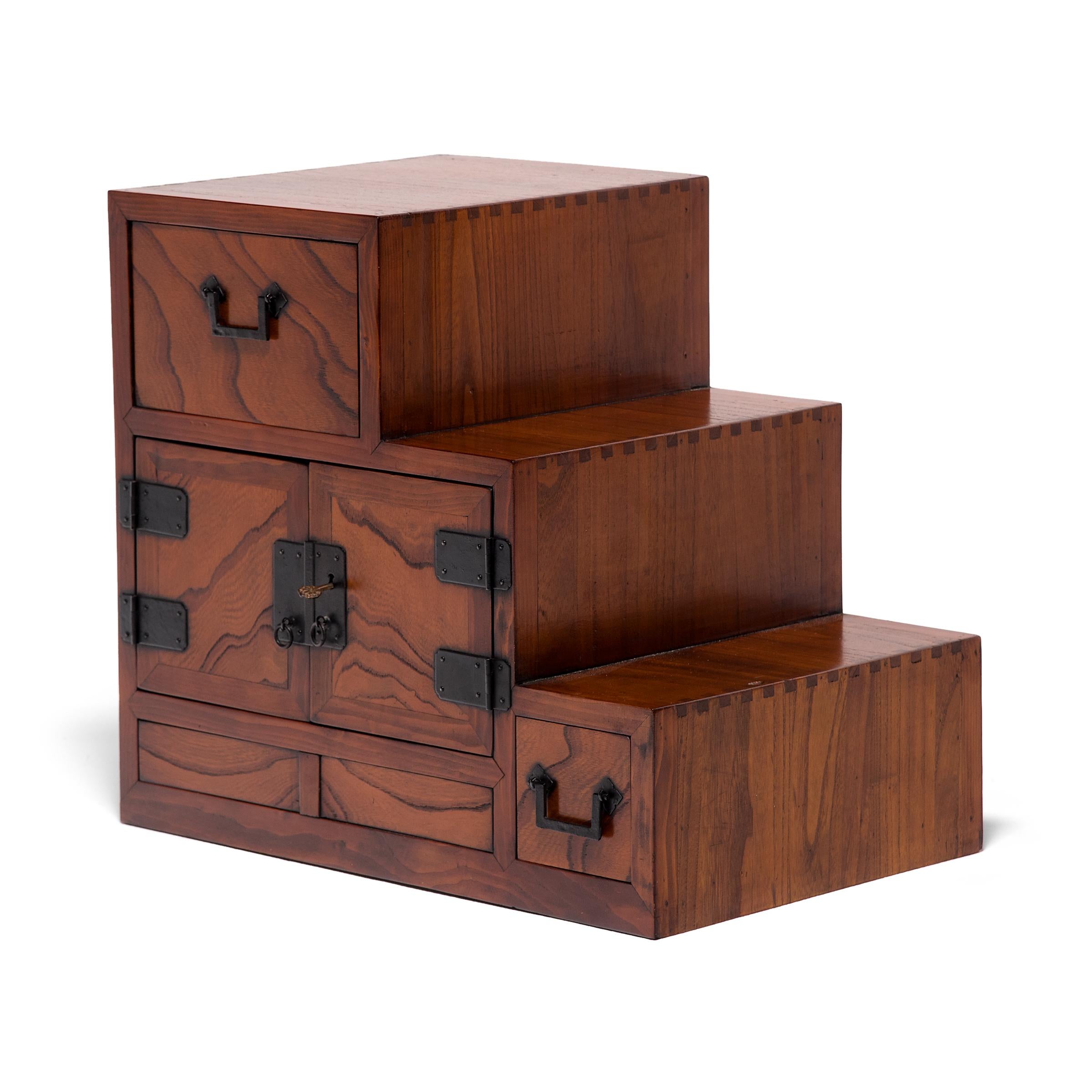 Designed to be versatile and portable, Japanese tansu chests were multipurpose storage cabinets that moved throughout the home as needed. This petite chest was originally the upper compartment of a large step tansu, known as kaidan-dansu, which
